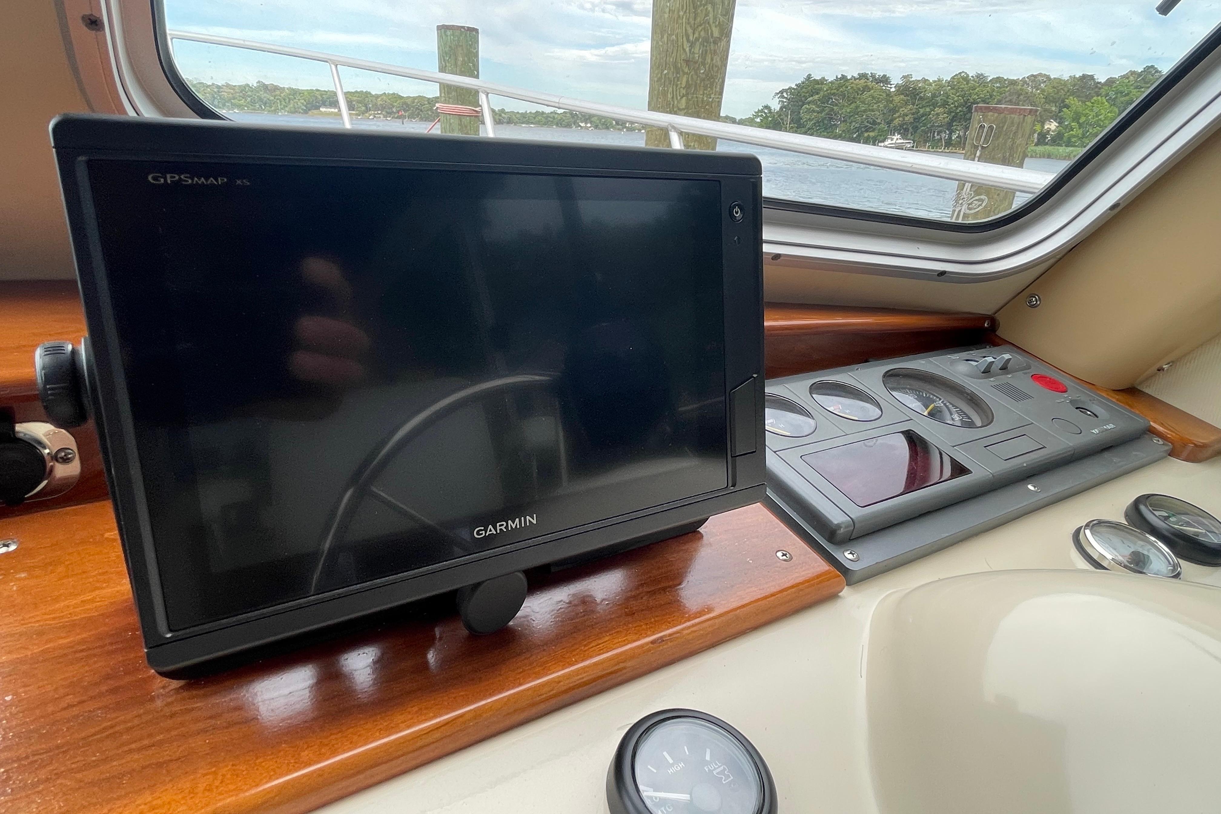 Garmin GPS system on 2005 Fox Island Thirty Sedan Cruiser dashboard, overlooking water.