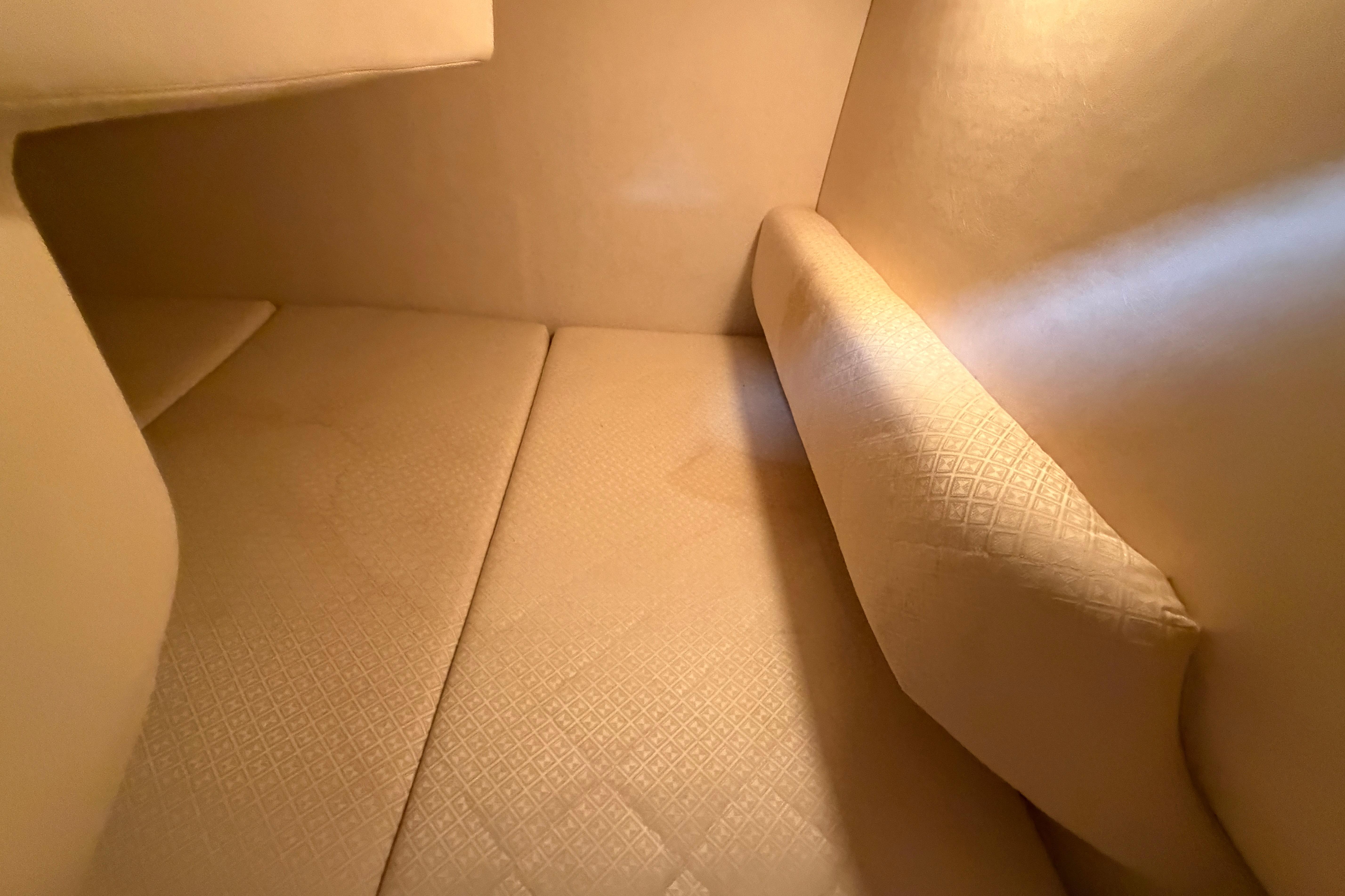 Interior cabin of 2004 Sea Ray Sundancer 260 with beige upholstery.