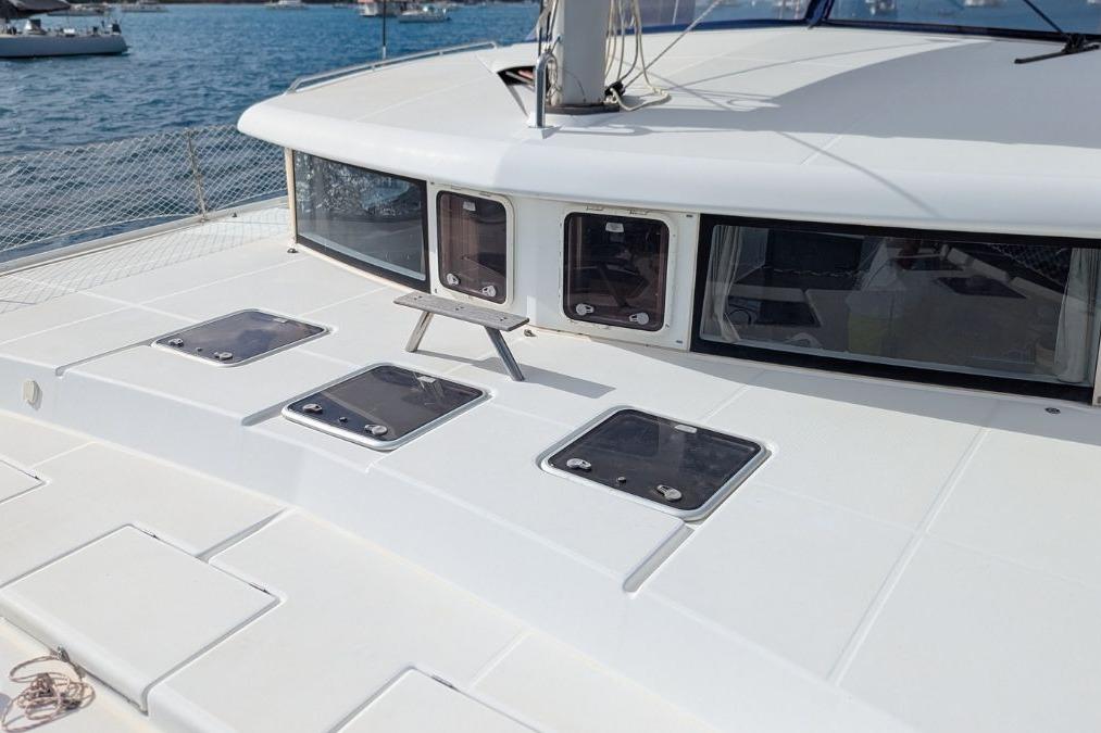 2008 Lagoon 420 catamaran deck with hatches, sailing on calm blue waters.