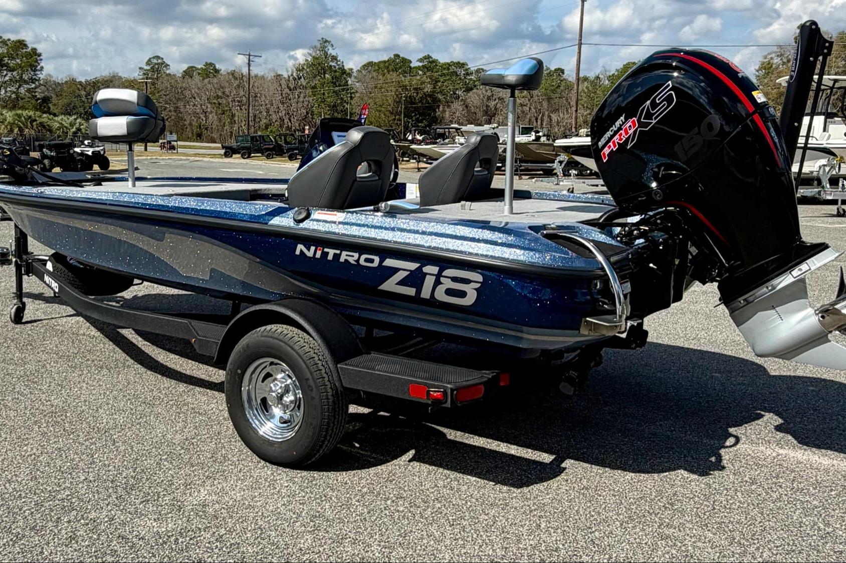 2026 Nitro Z18 boat with powerful engine, parked on a trailer in a sunny outdoor setting.