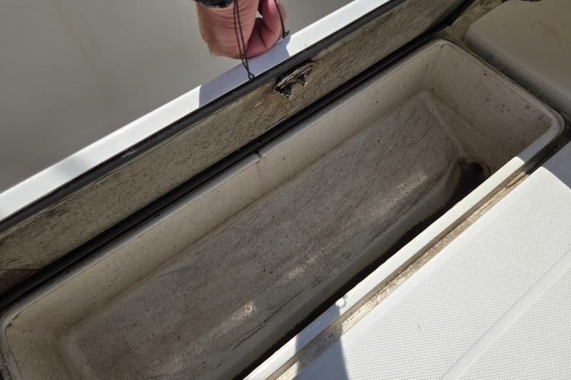 Open storage compartment on 2004 Aquasport 215 Osprey Sport boat.