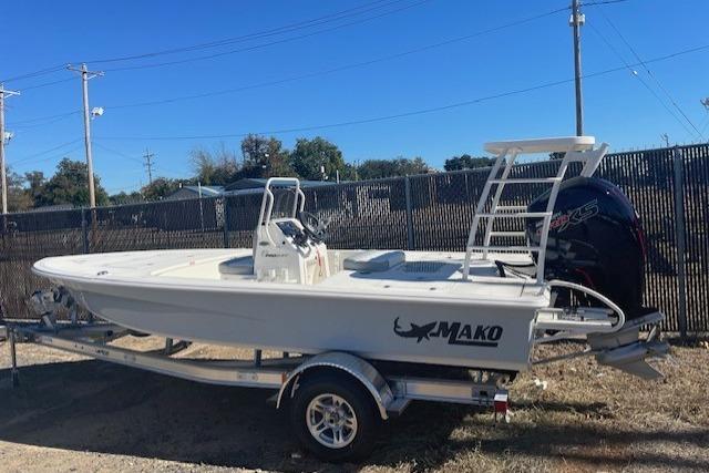 2026 Mako 18 Pro Skiff boat on trailer, parked outdoors.