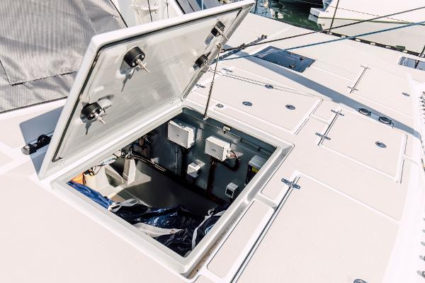 Open hatch on Vision 444 yacht, revealing interior storage and electrical components.