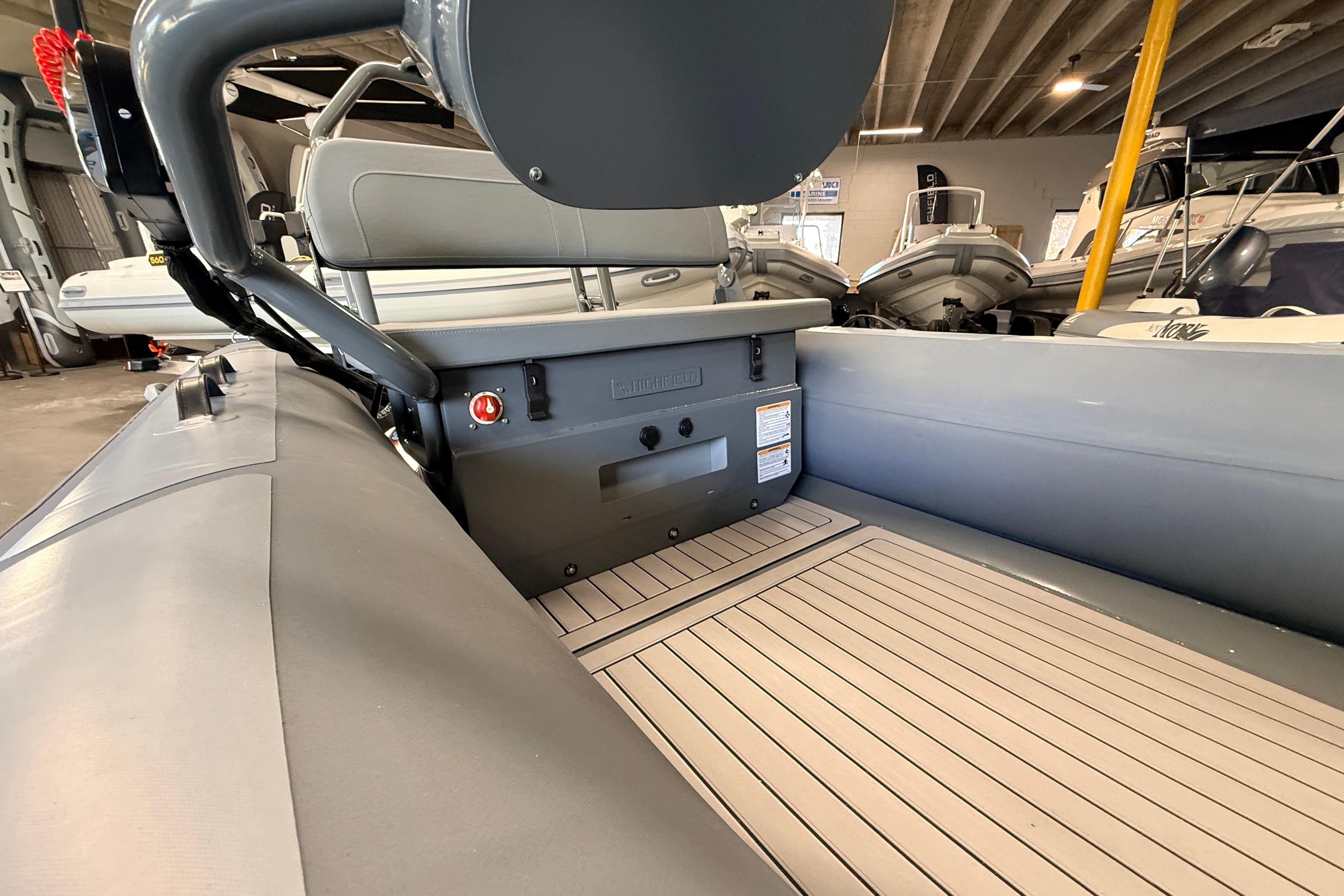 2026 Highfield Classic 400 boat interior with gray seating and wood-patterned flooring.