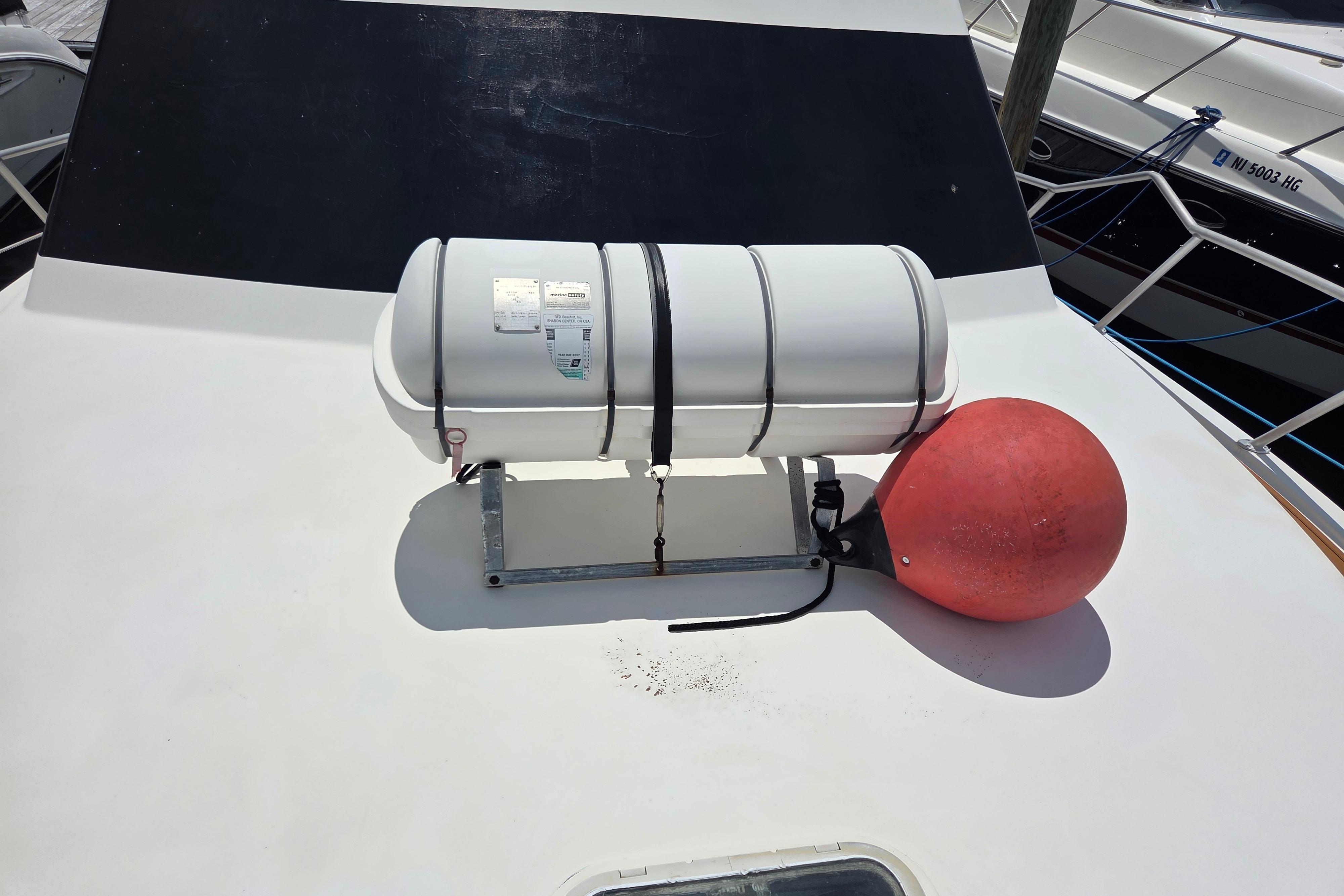 Life raft and buoy on 1990 Egg Harbor Golden Egg 42 yacht deck.