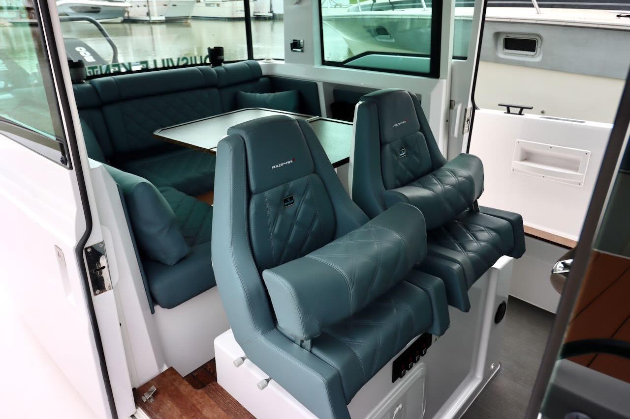 Interior of 2022 Axopar 37 XC Cross Cabin with luxurious seating and table.