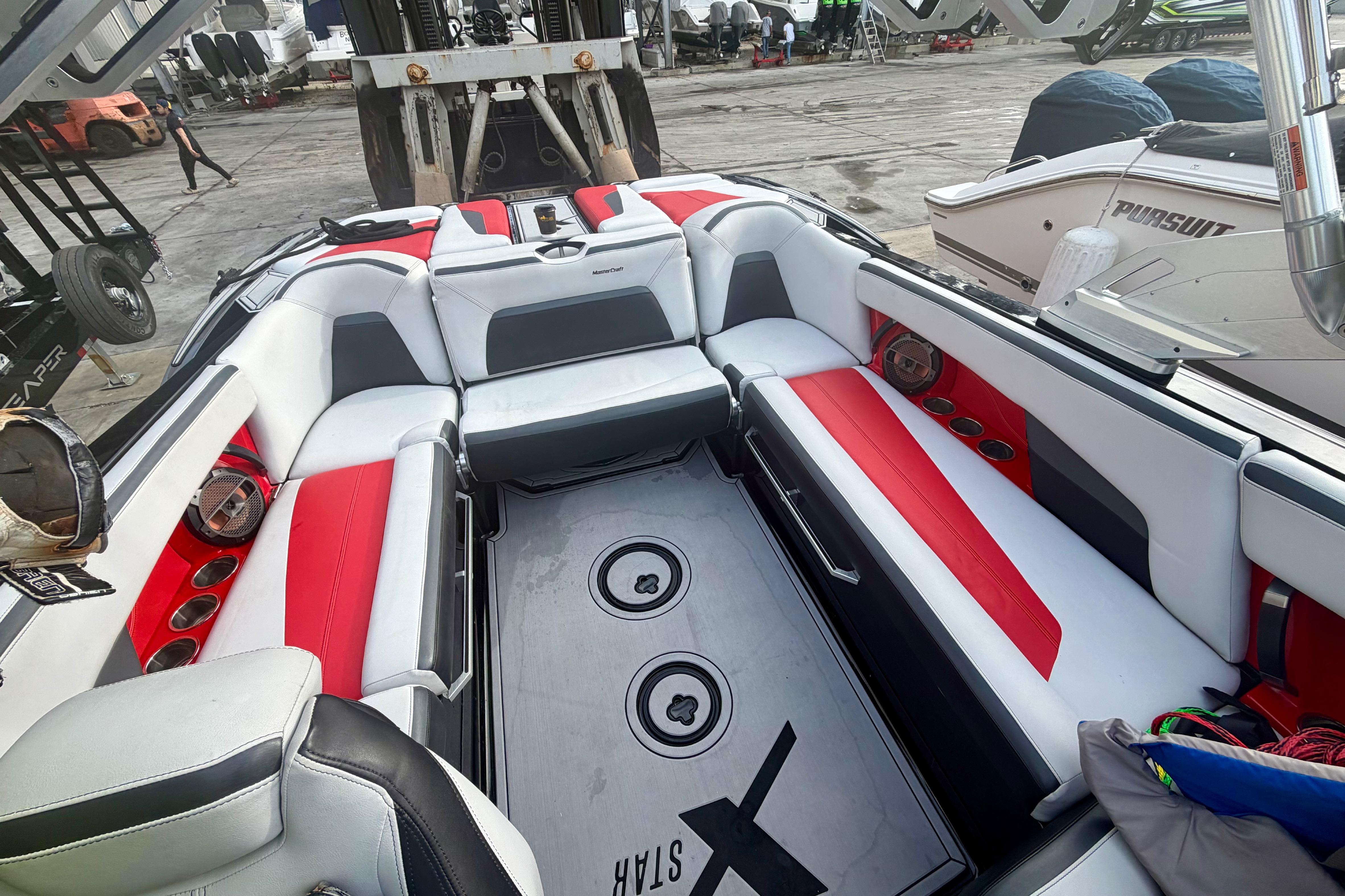 2019 MasterCraft XStar boat interior with red and white seating, docked at a marina.