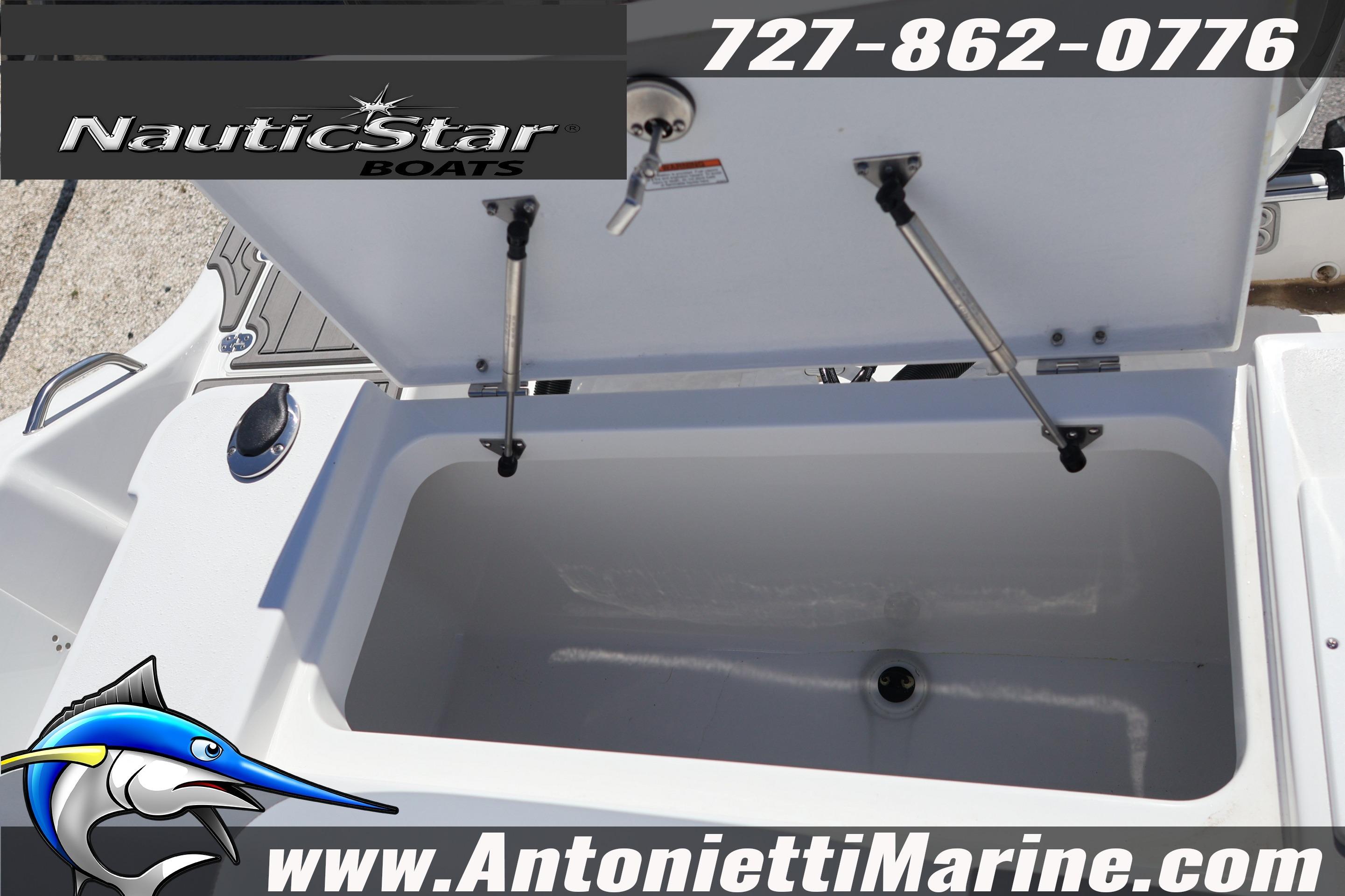 Open storage compartment on 2026 NauticStar 292 Legacy boat, featuring hydraulic supports.