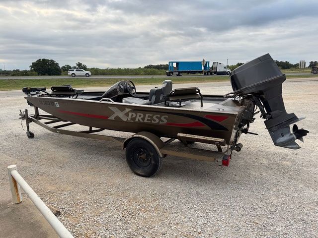2001 Xpress X51 boat on trailer, parked outdoors on gravel.