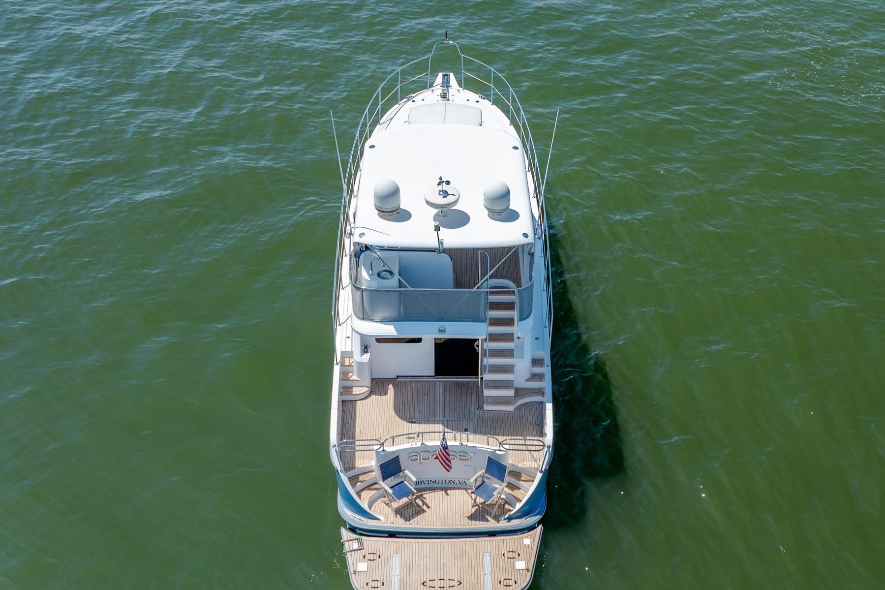 Aerial view of Ocean Alexander yacht on calm green water.