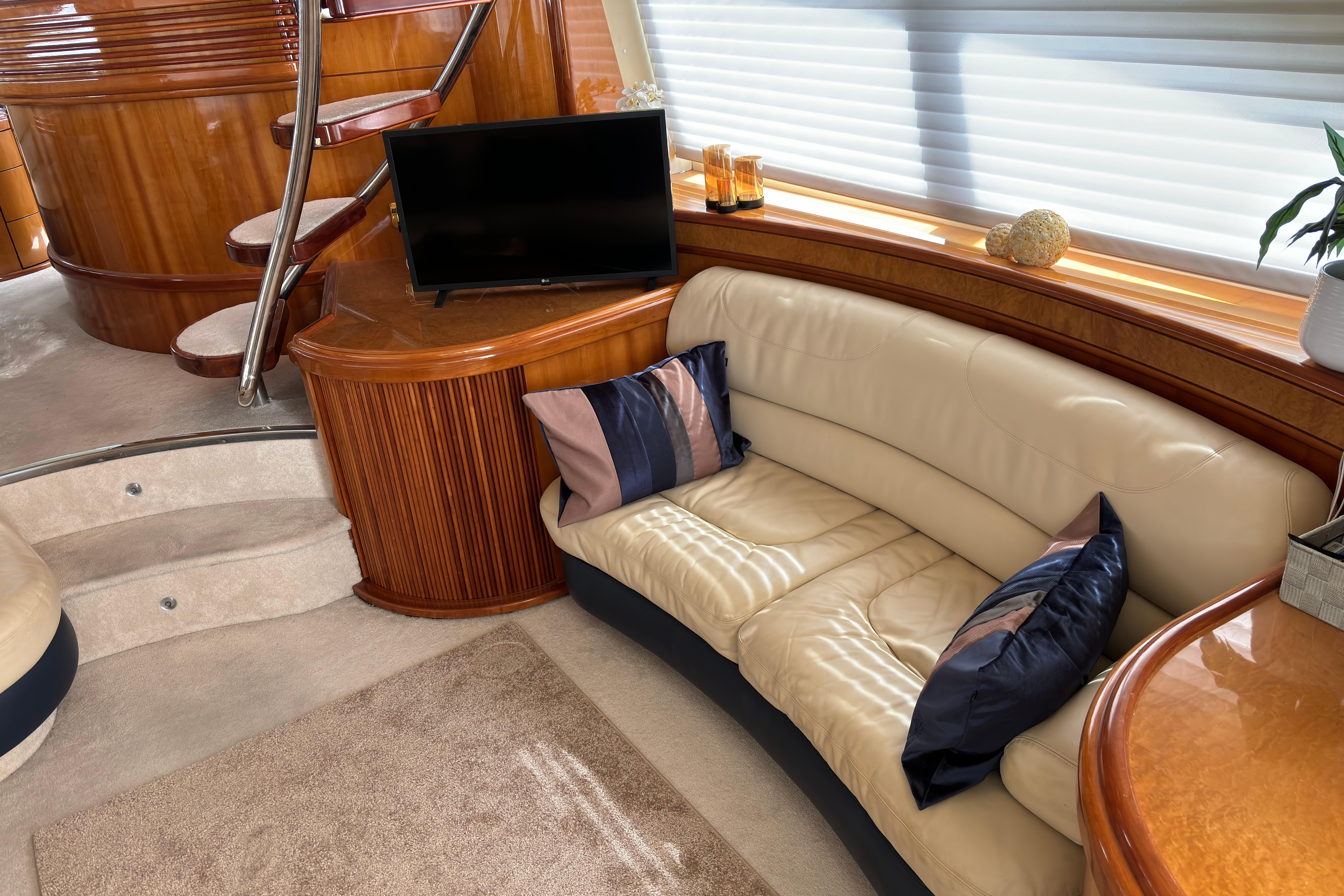 Luxurious interior of a 2002 Azimut 68 Plus yacht with elegant seating and decor.