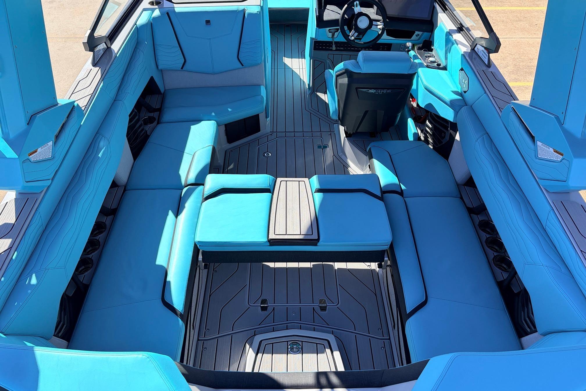 Interior of 2026 Nautique Super Air Nautique G23, featuring luxurious blue seating and modern design.