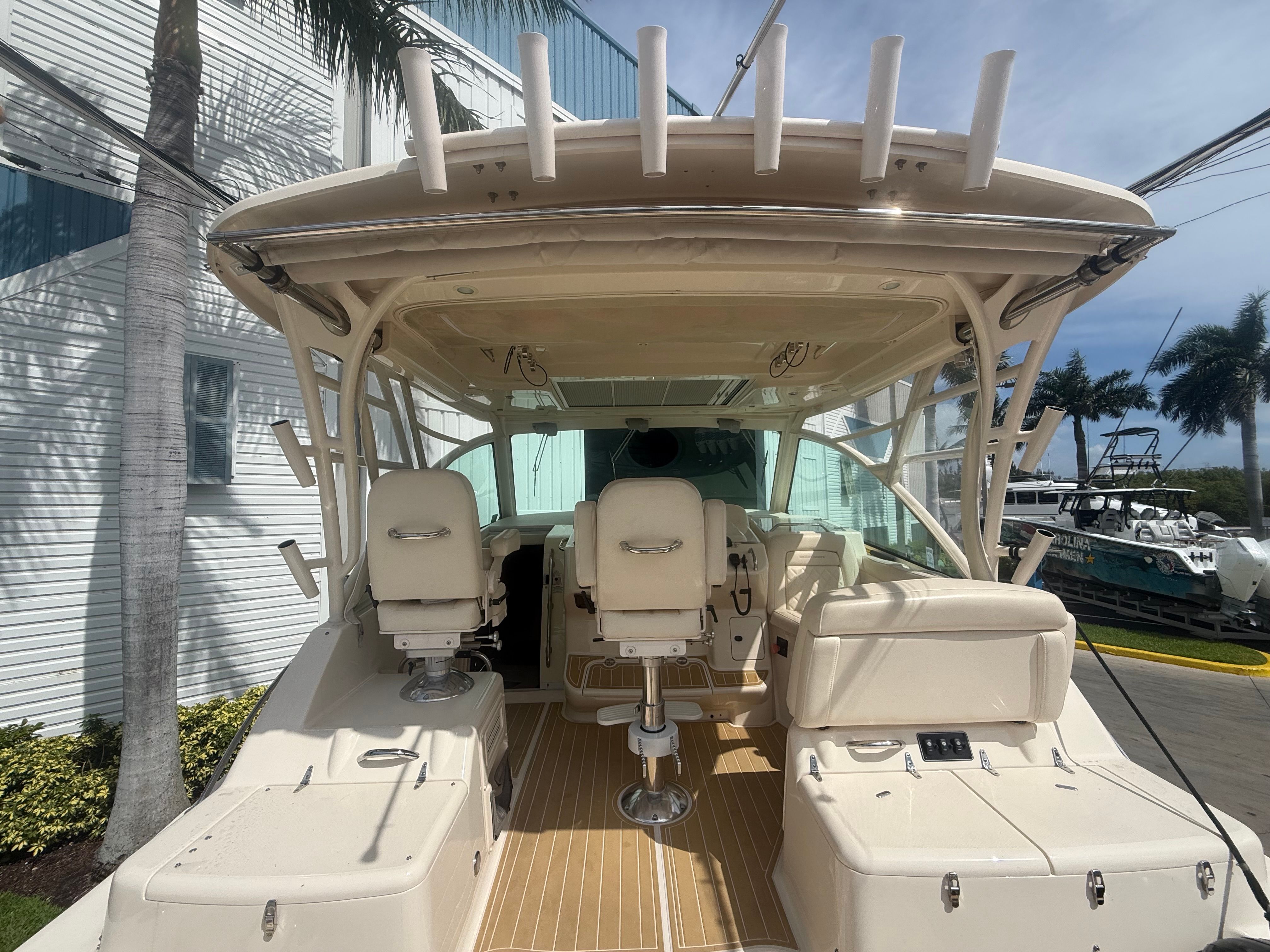 The image shows the cockpit of a 2018 Grady-White Express 370 with two seats and a helm.