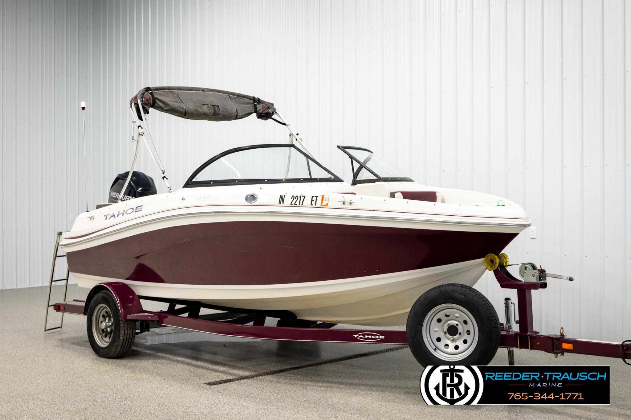 2016 Tahoe 450 TS boat on trailer in indoor showroom.