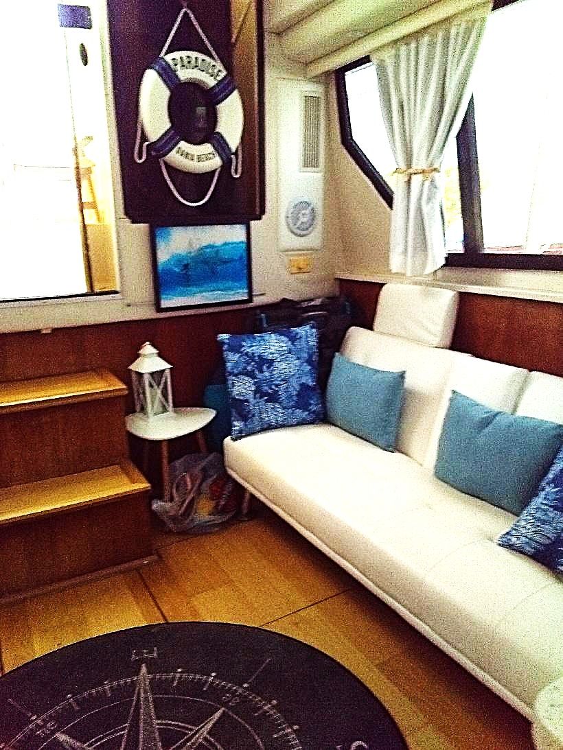Interior of a 1995 Carver 35 with a sofa and nautical decor.