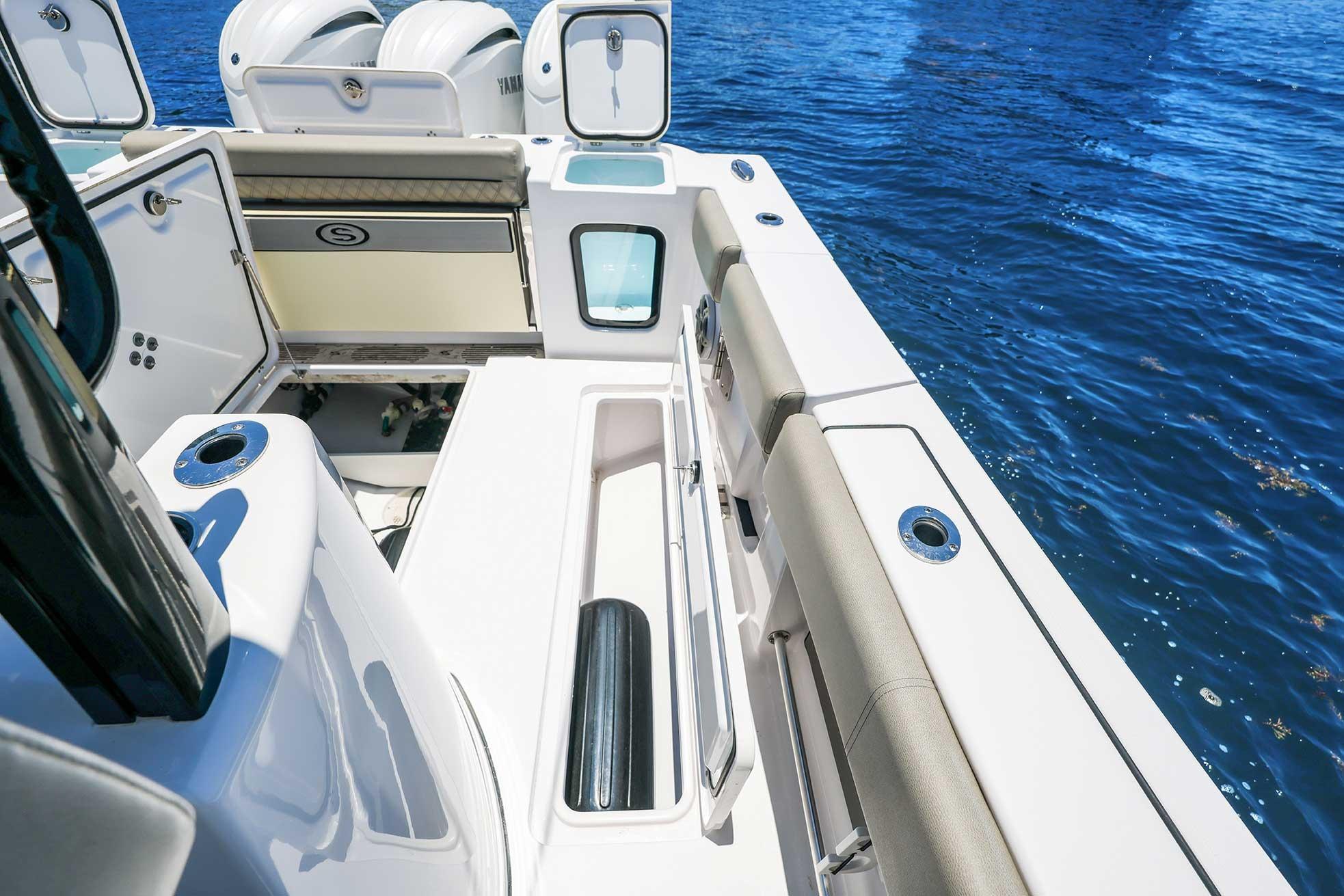 2024 Sportsman Open 352 Center Console boat deck with seating and storage, on blue water.