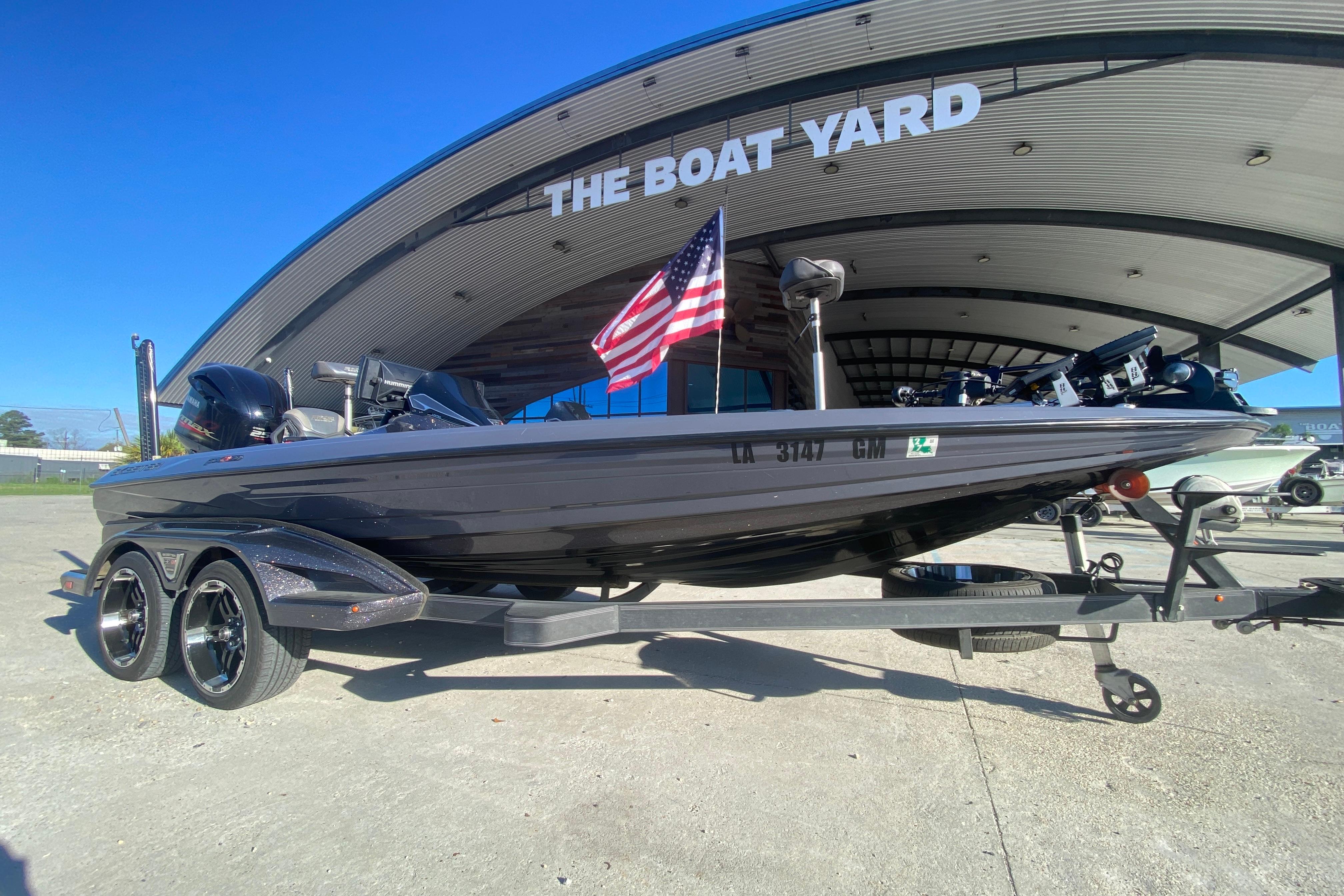 2020 Skeeter FXR20 Limited boat on trailer at dealership, American flag displayed.