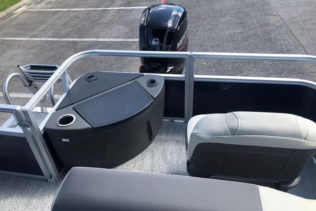 2026 Sun Tracker Bass Buggy 18 DLX pontoon boat interior with seating and motor.
