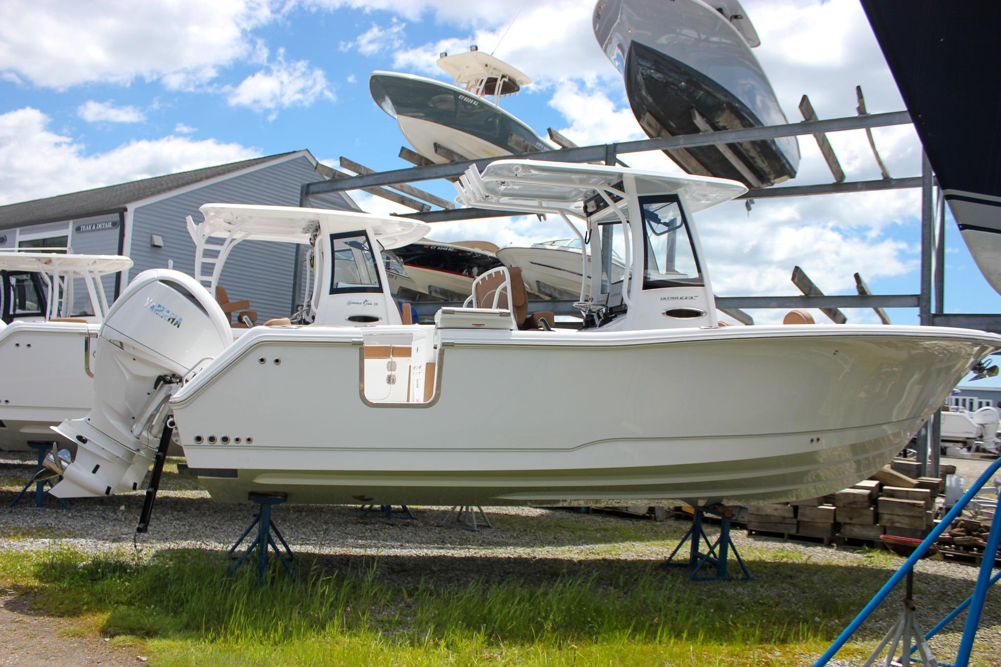 2027 Sea Hunt Ultra 275 SE boat displayed on stands at a marina.