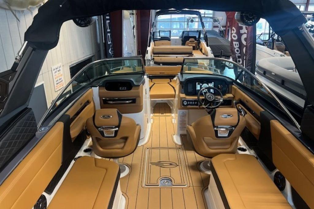 2025 Chaparral 2870 SSX boat interior with luxurious tan seating and modern dashboard.