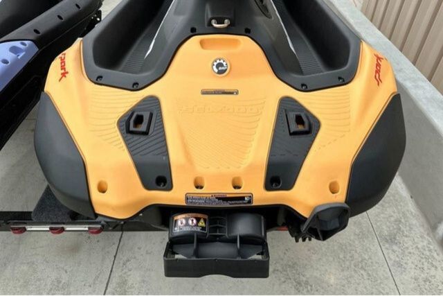 Rear view of a Sea-Doo jet ski with yellow bodywork on a trailer.
