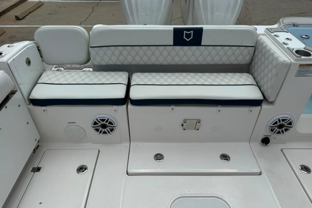 2026 Sea Fox 288 Traveler boat seating area with cushioned bench and speakers.