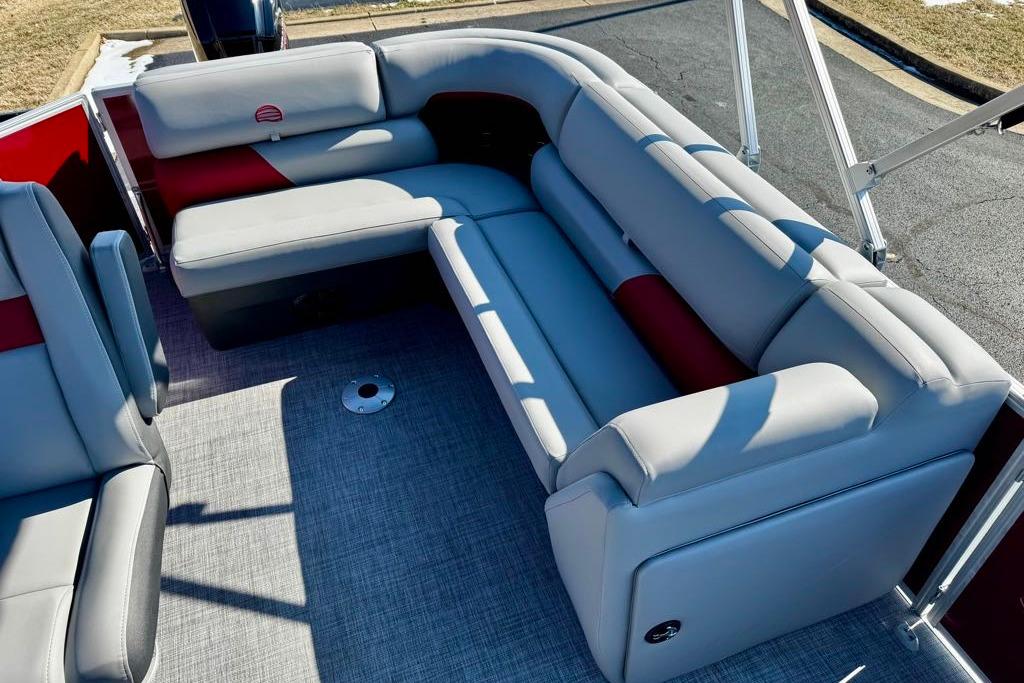 2026 Sun Tracker Party Barge 20 DLX with spacious gray seating and red accents.