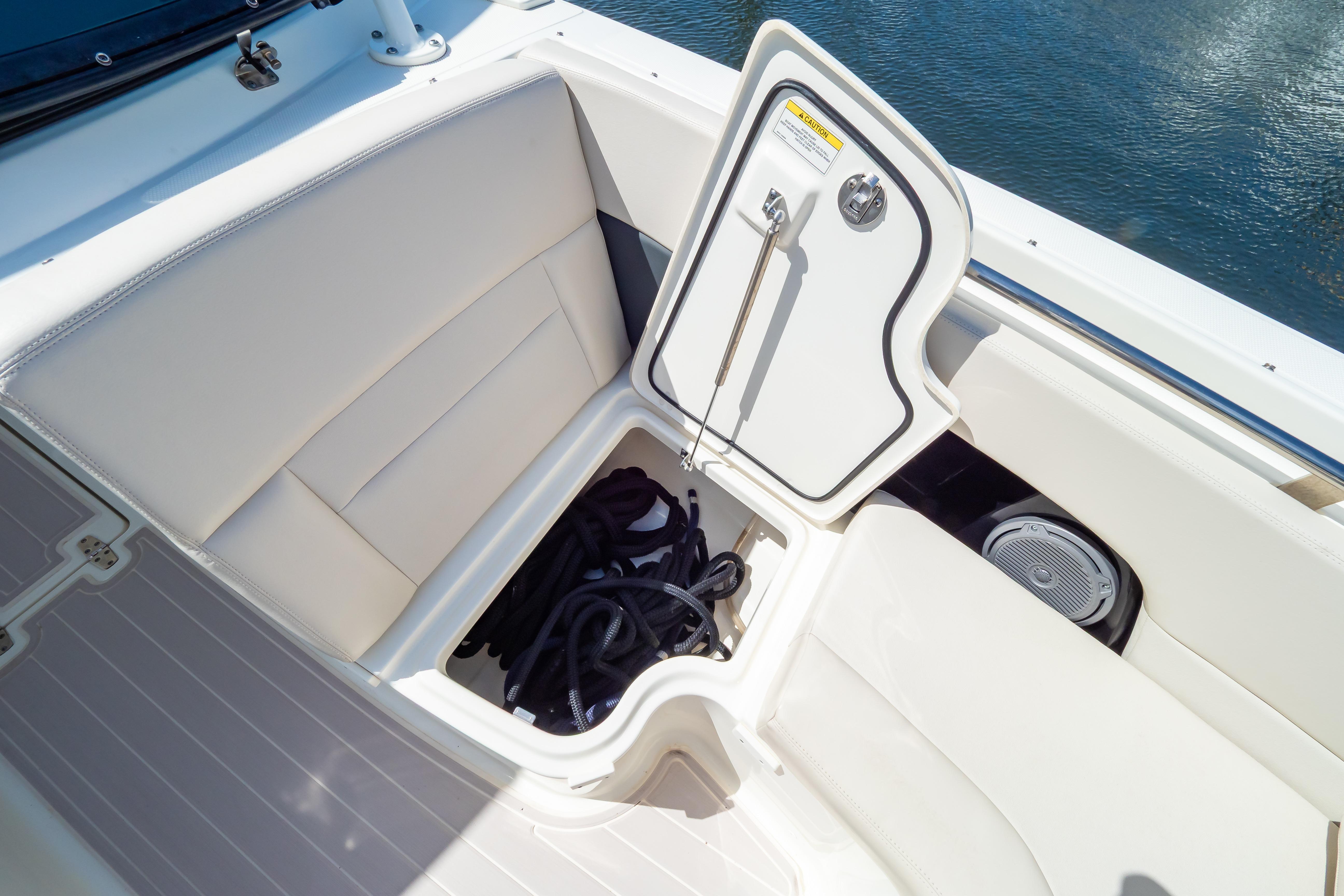 2019 Boston Whaler 270 Vantage boat storage compartment with open hatch and coiled rope.