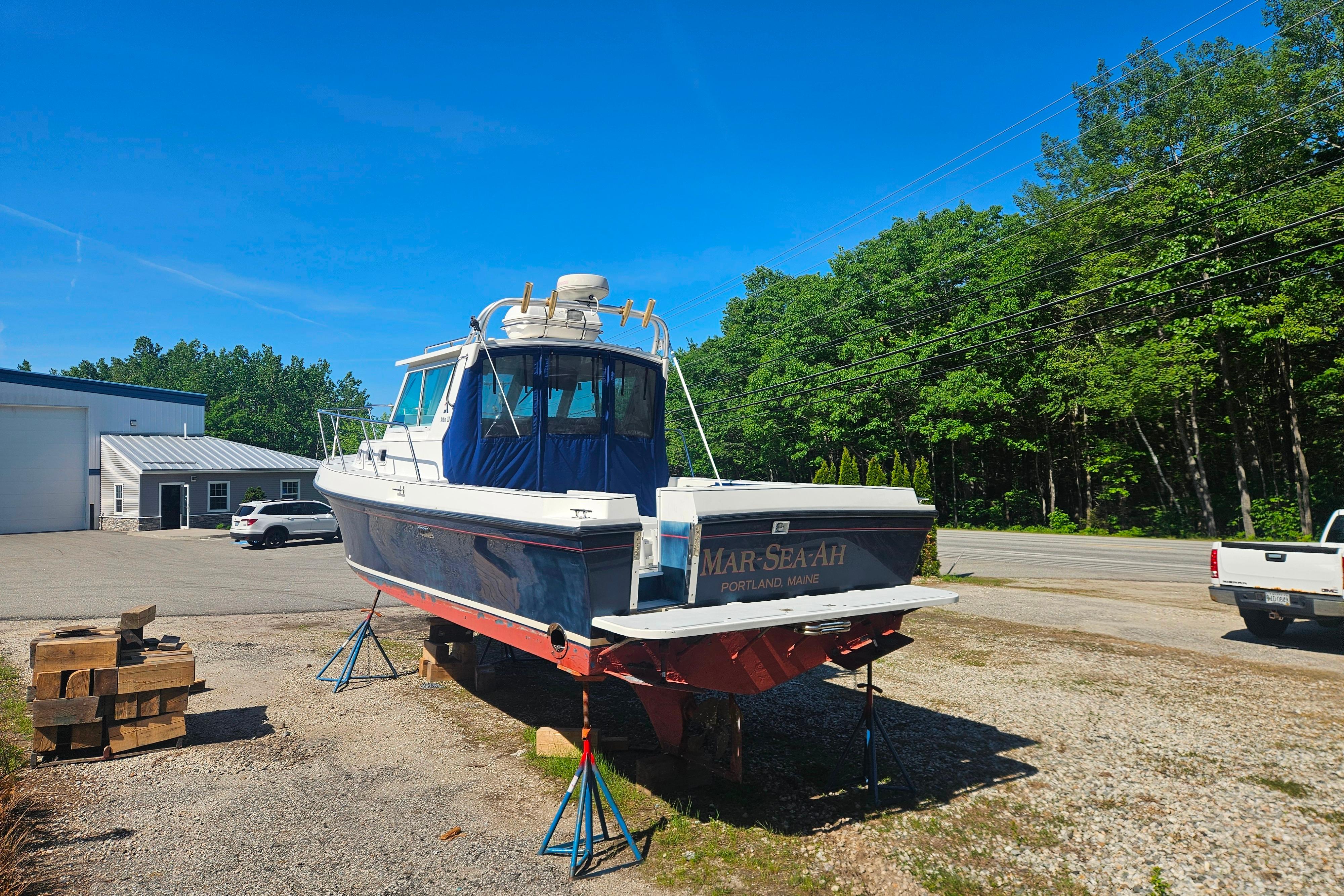 1999 Albin 28 Tournament Express boat on stands, sunny day, Portland, Maine.