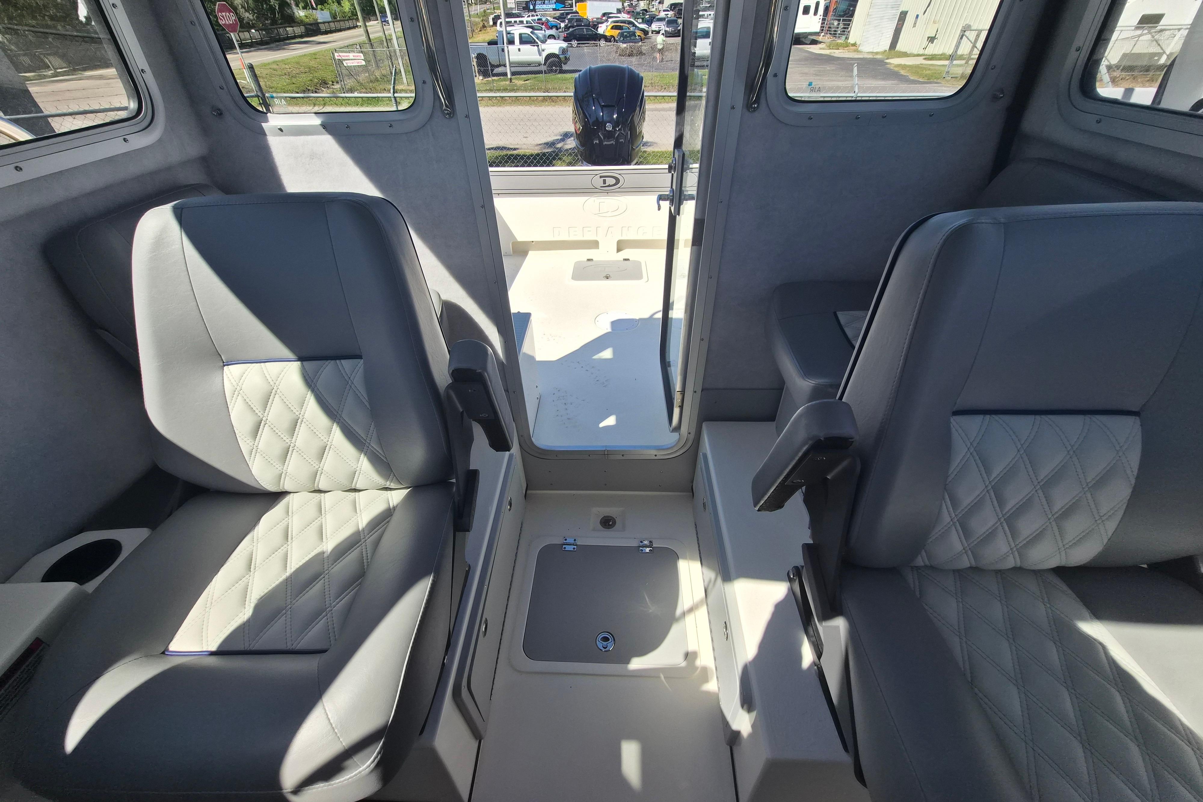 Interior of 2026 Defiance Admiral 220 EX boat with two cushioned seats.