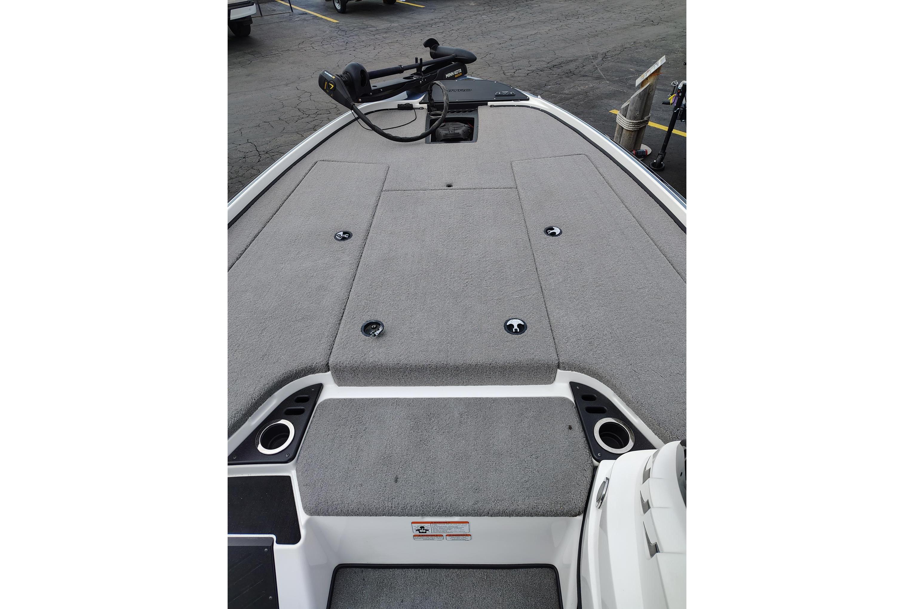 2024 Nitro Z20 boat deck with gray carpet and fishing equipment.