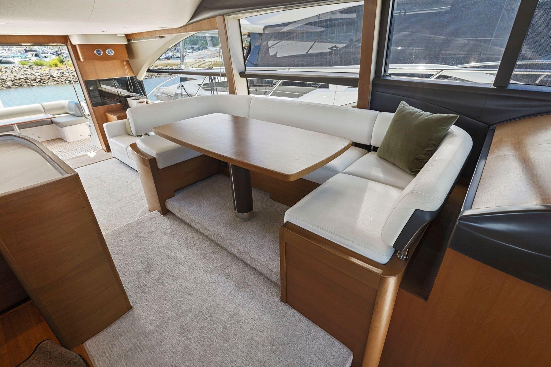 Luxurious interior of 2015 Princess 60 Flybridge Motor Yacht with elegant seating and dining area.