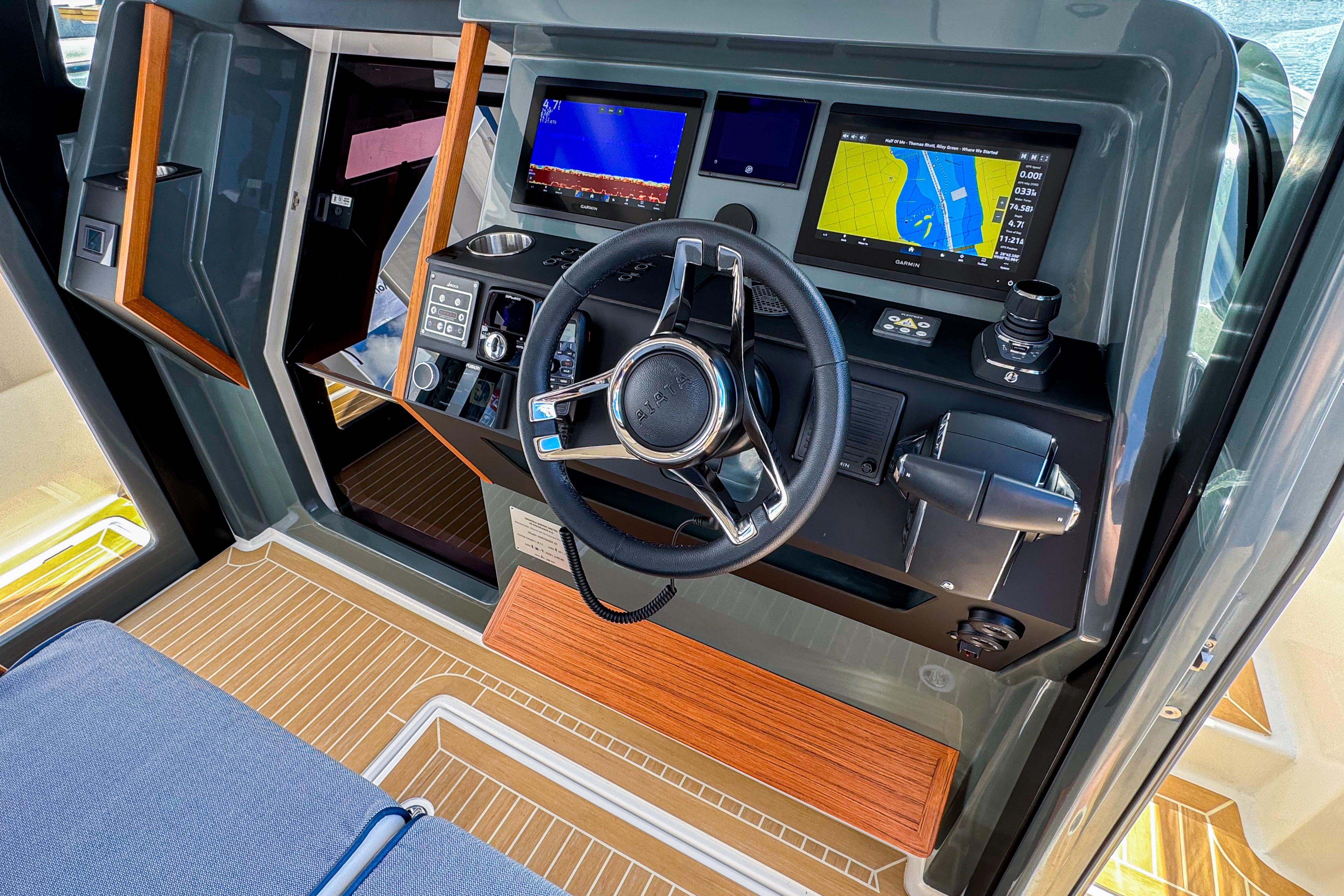 2025 Aiata Wayfinder 38 Cabin helm with advanced navigation displays and controls.