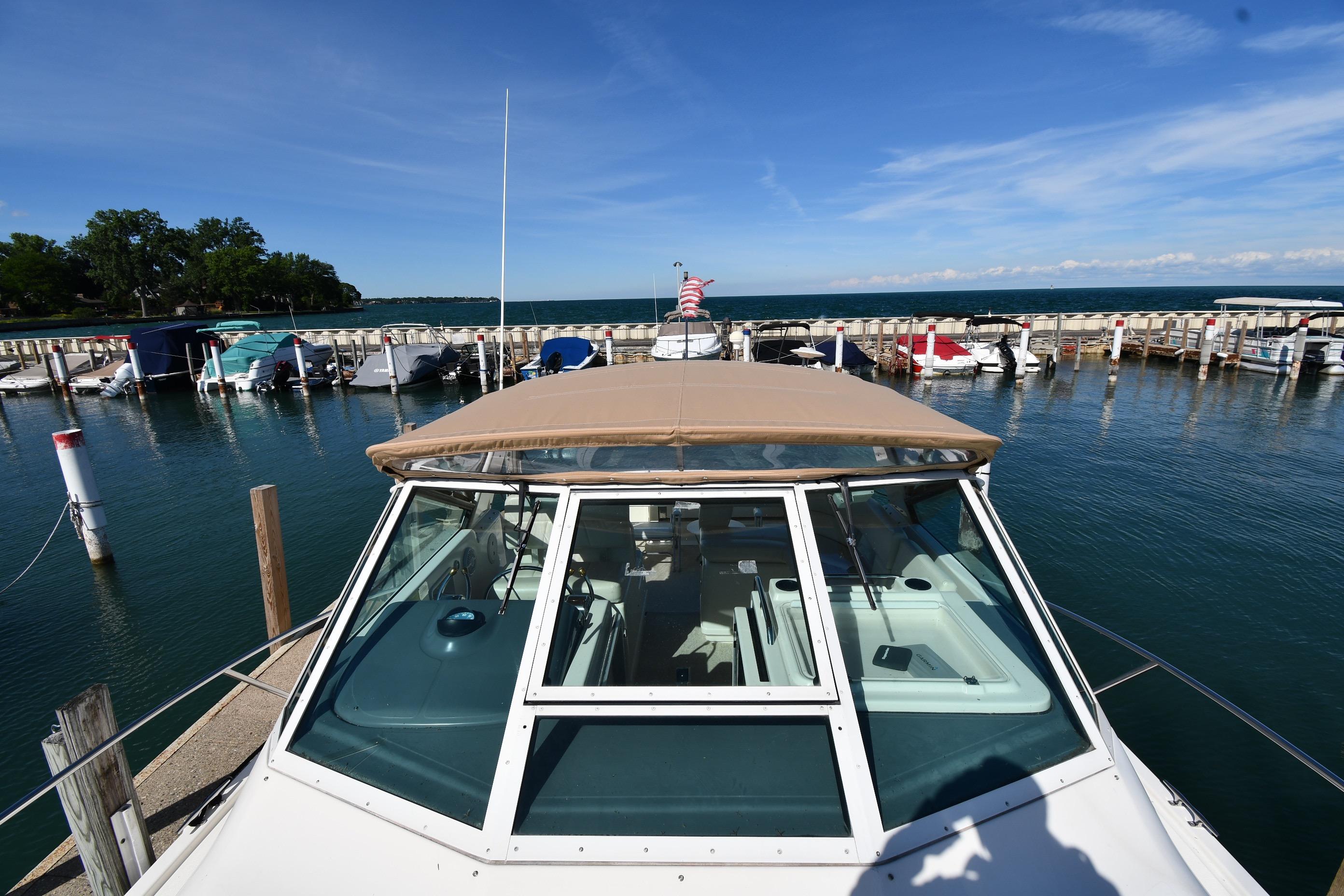 1998 Tiara Yachts 3100 Open docked at marina under clear blue sky.