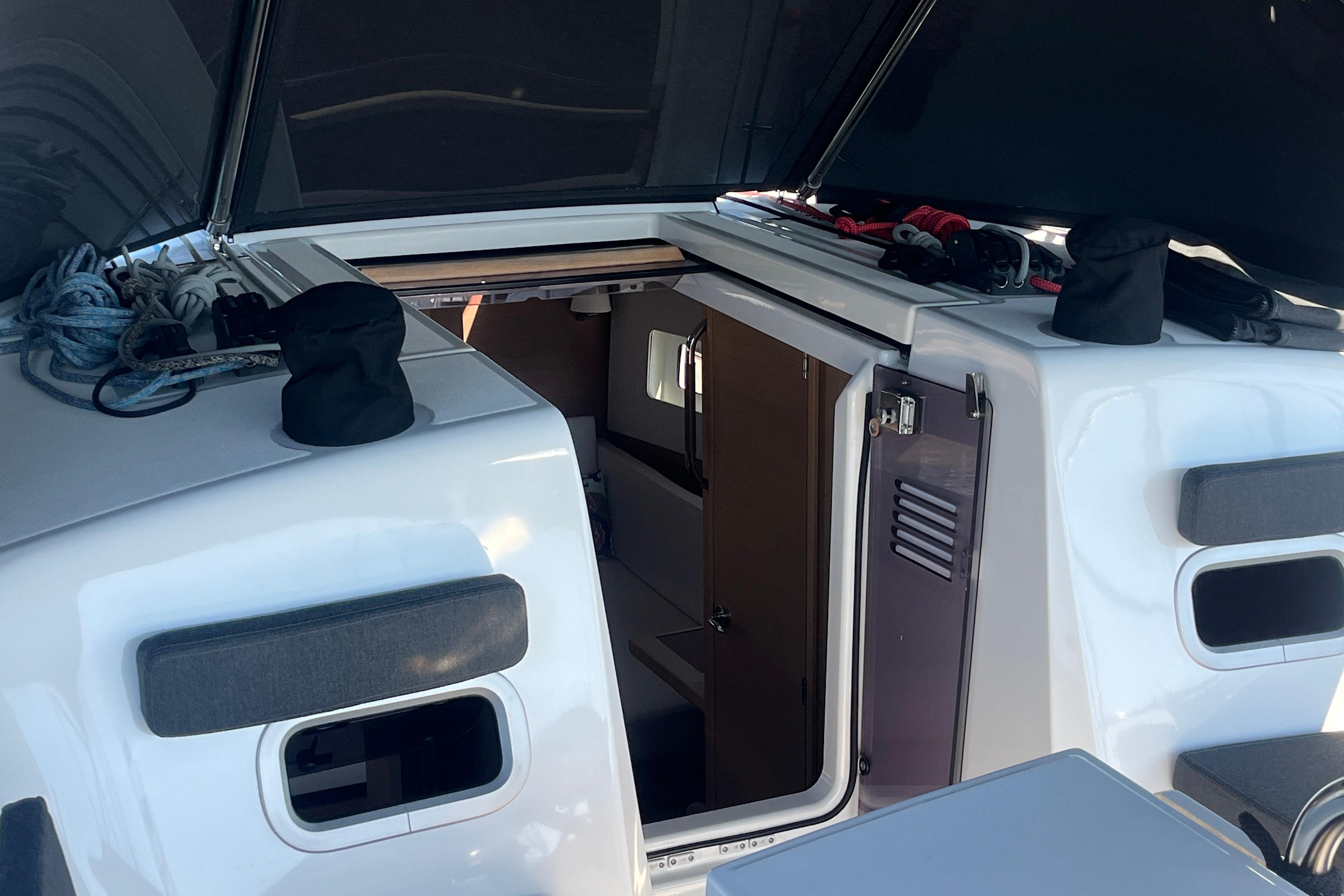 2023 Jeanneau Sun Odyssey 380 yacht cockpit with open hatch and visible interior.