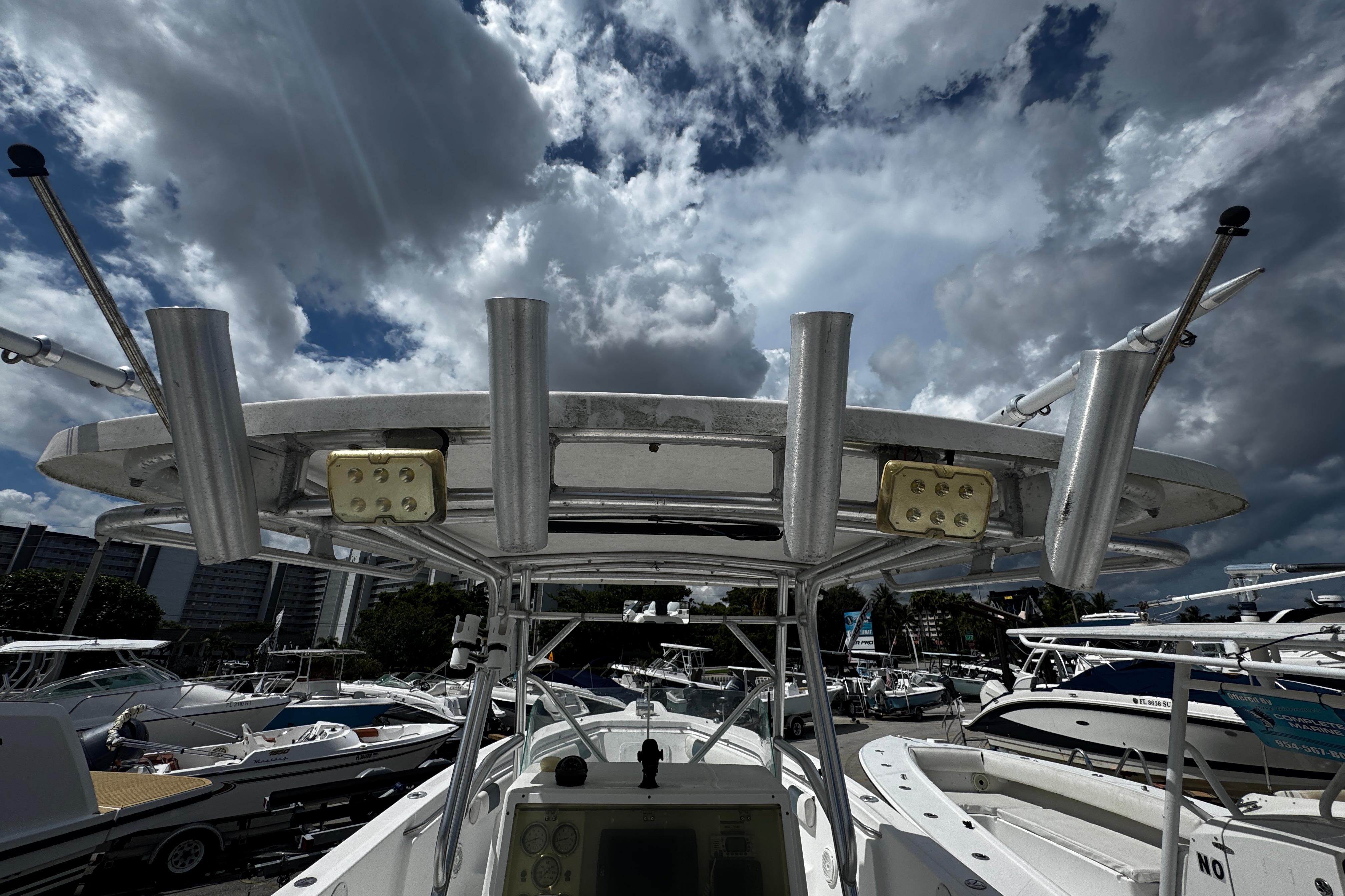 2008 Sea Fox 287 CC boat with rod holders and electronics, under a cloudy sky.