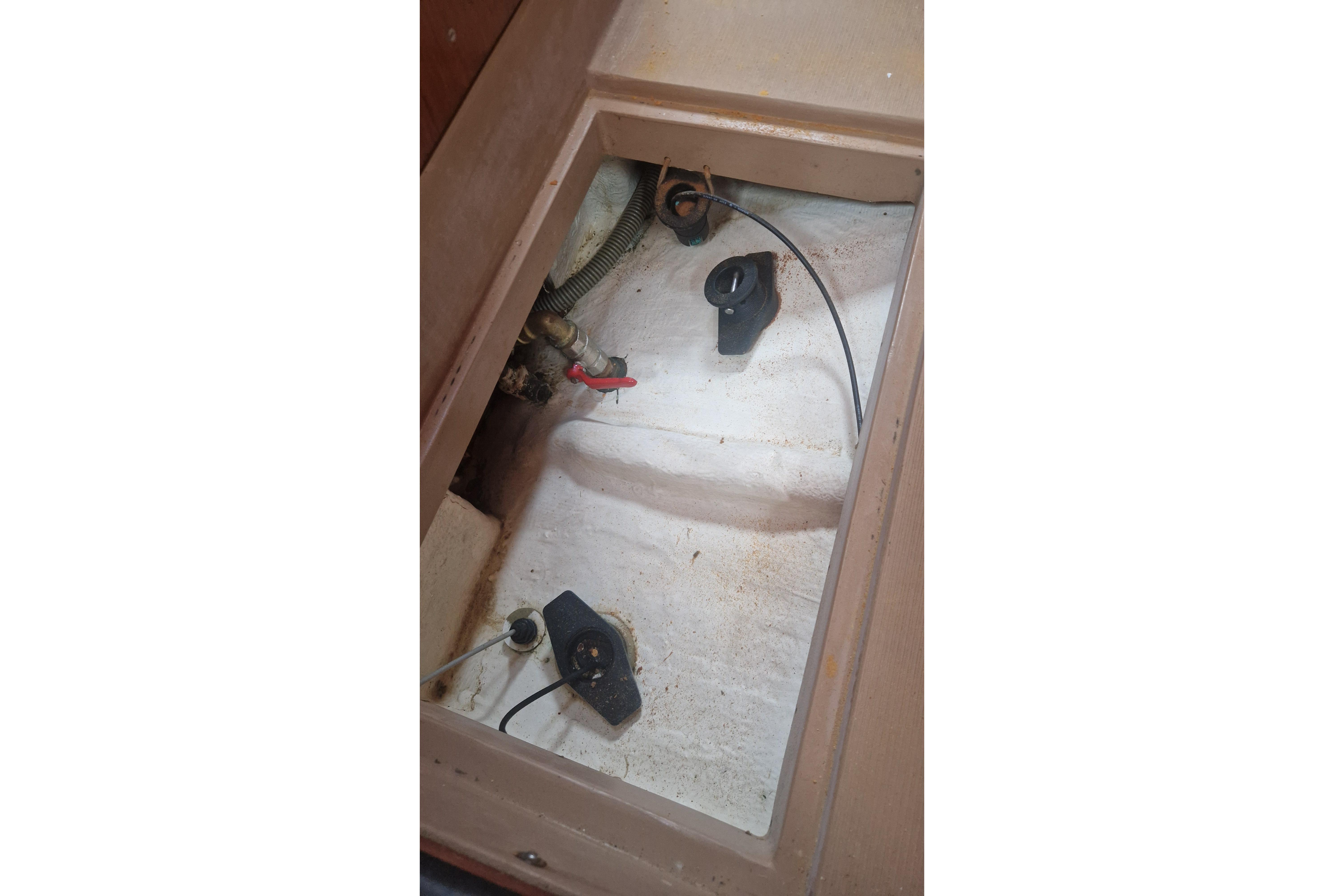 1980 Amel Sharki boat compartment with cables and fittings.