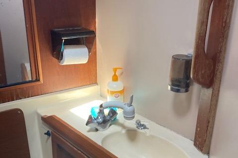 Bathroom sink area in 1988 Westerly Corsair 36 yacht with soap dispenser and mirror.