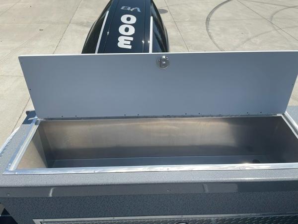 Open storage compartment on a 2025 Spartan 240 Maximus Pro boat, with a 300 HP engine.