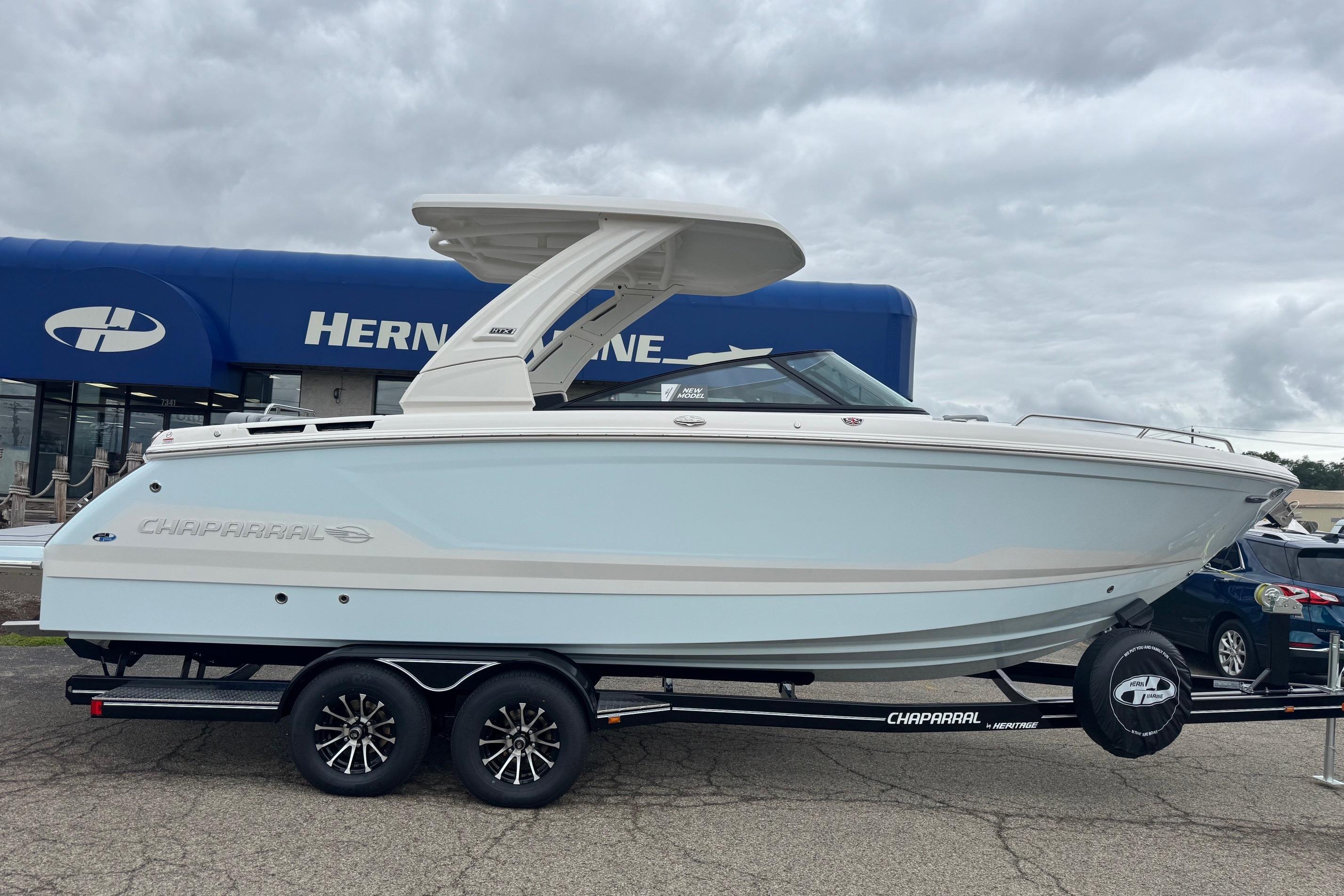 2026 Chaparral 8 SSX boat on trailer at dealership, overcast sky.