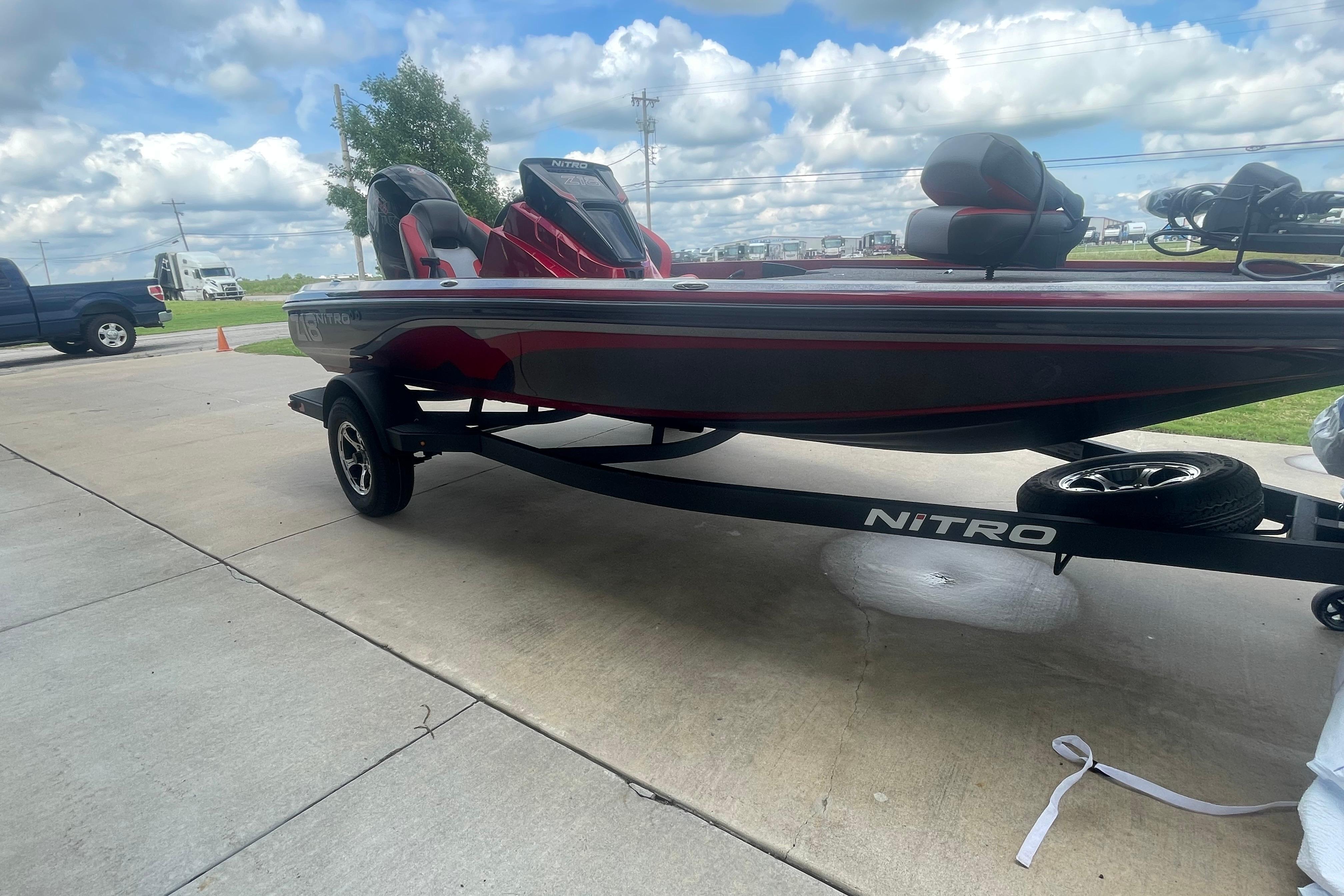 2026 Nitro Z18 Pro boat on trailer, parked outdoors under cloudy sky.