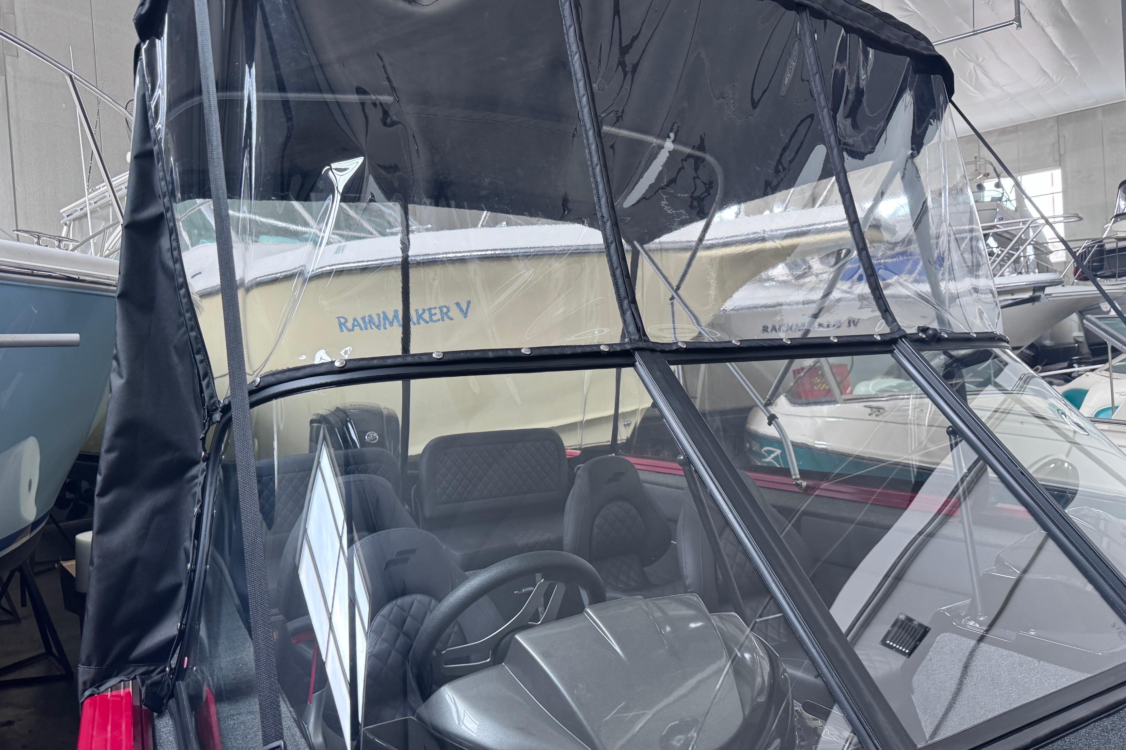 2026 Starweld 18 SXT boat with protective canopy in a showroom.