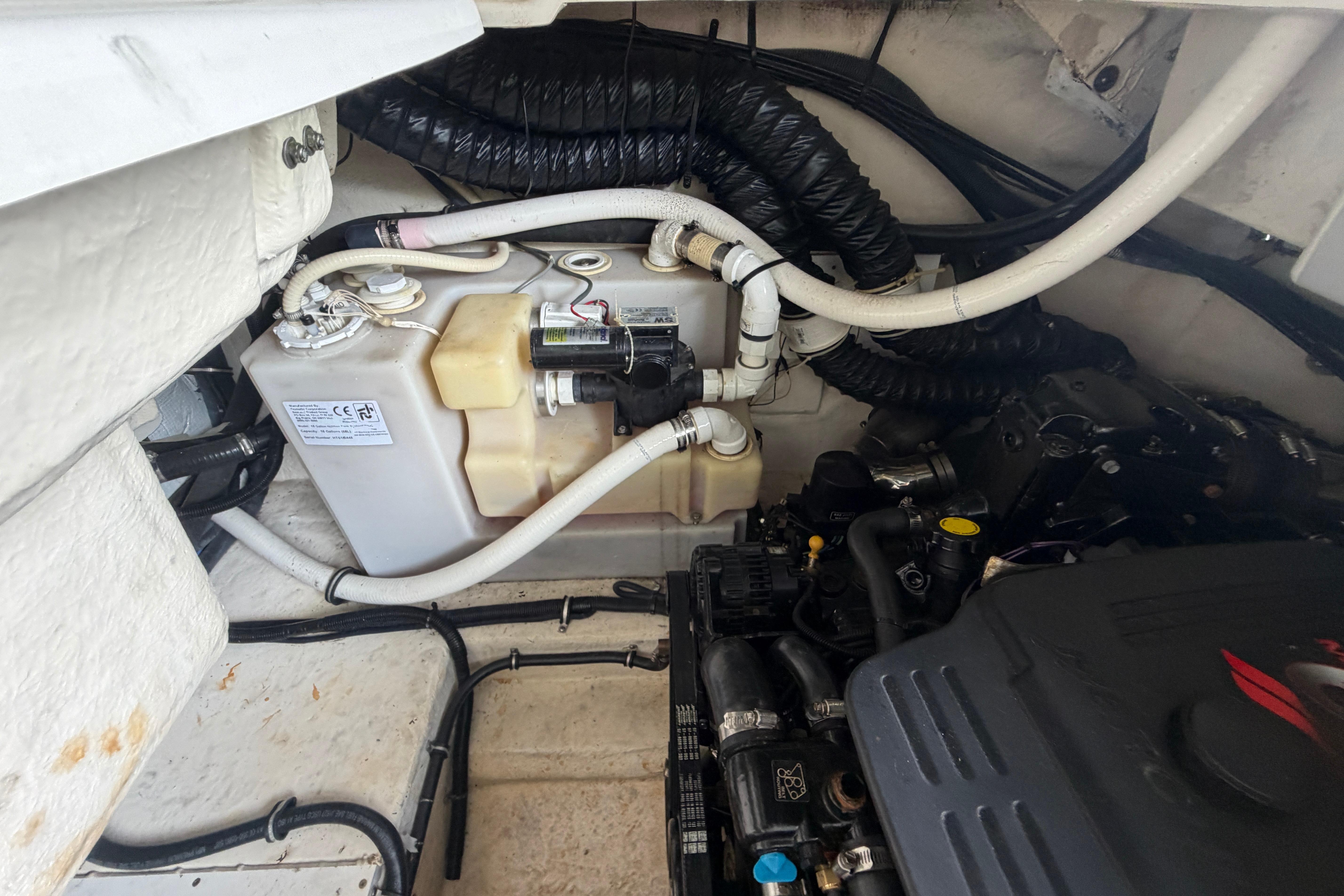 Engine compartment of a 2007 Monterey 298SSX Super Sport boat, showing hoses and components.