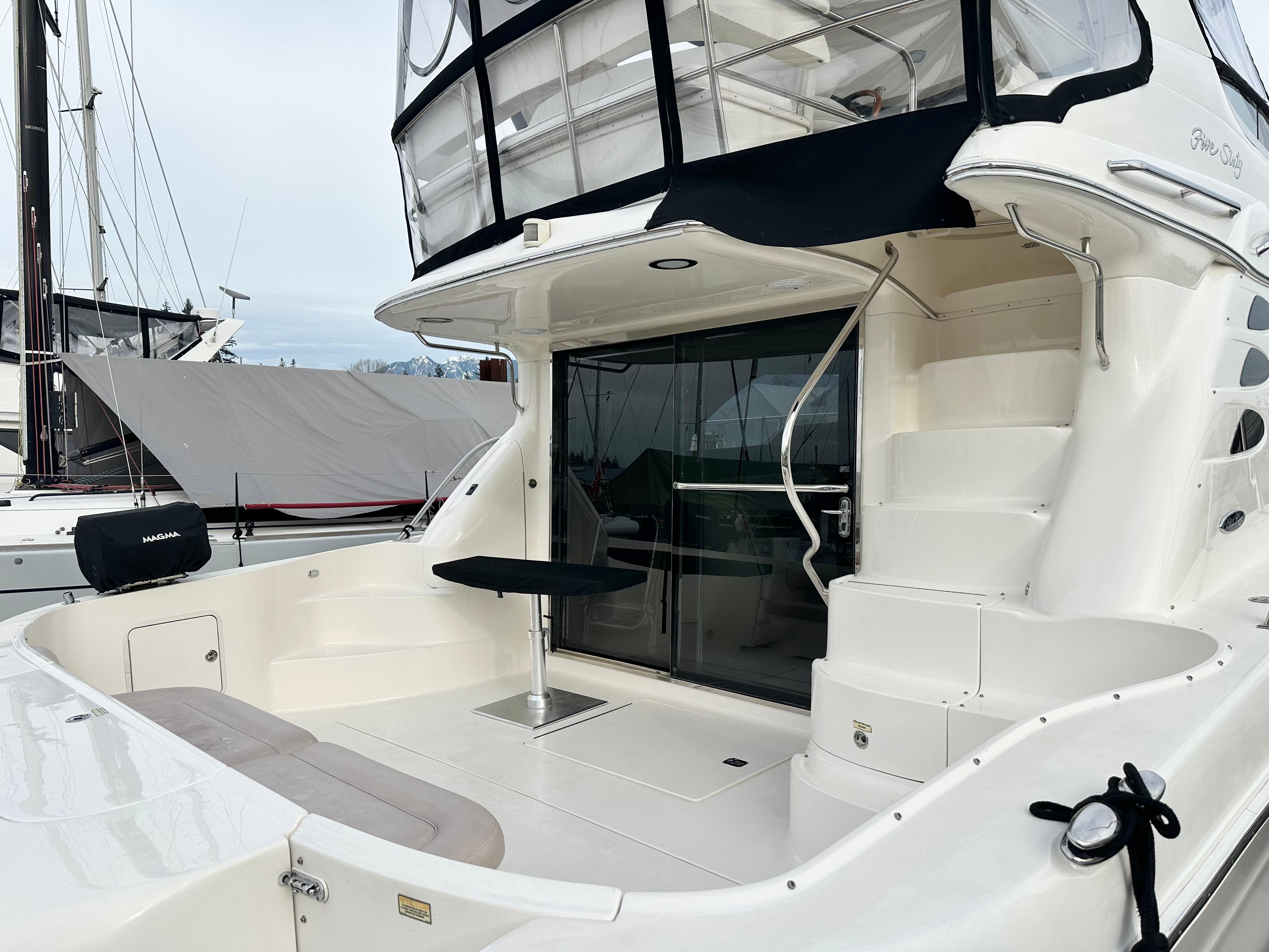 2002 Sea Ray 560 Sedan Bridge yacht with spacious deck and elegant design.