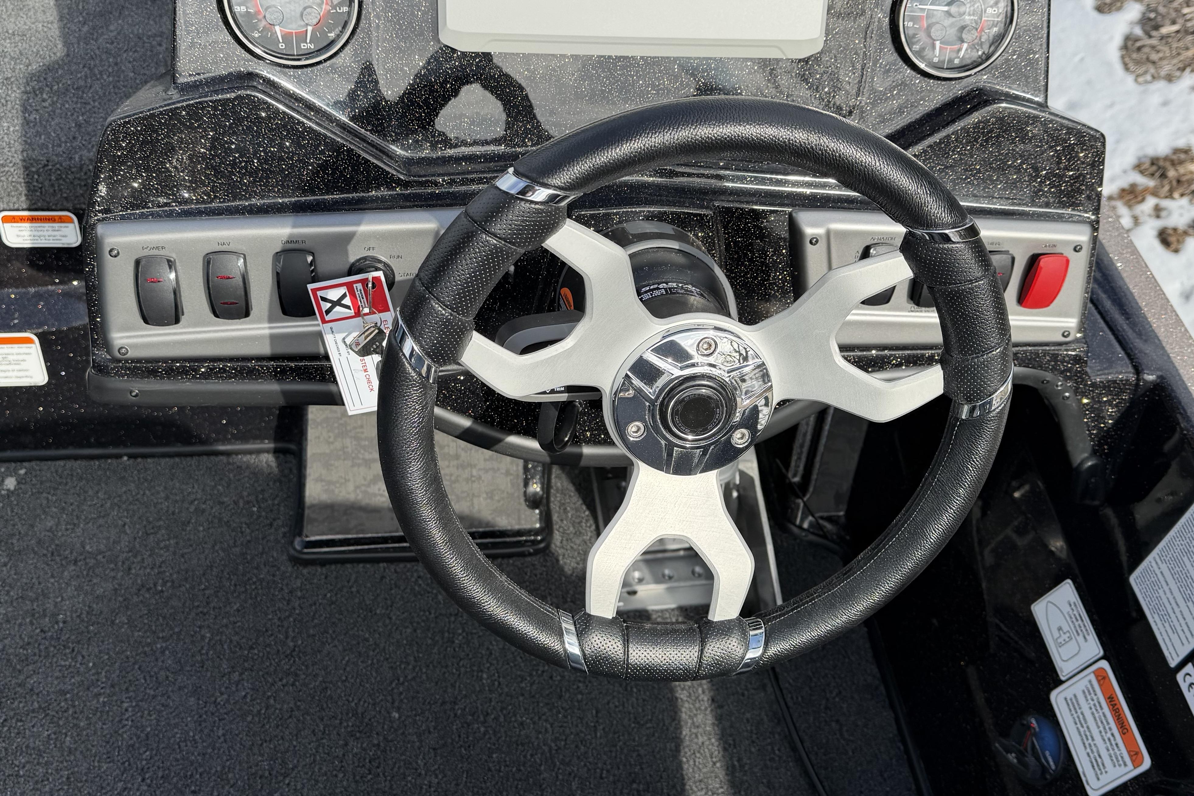 Steering wheel of 2026 Nitro Z19 XL Pro boat with control panel and gauges.