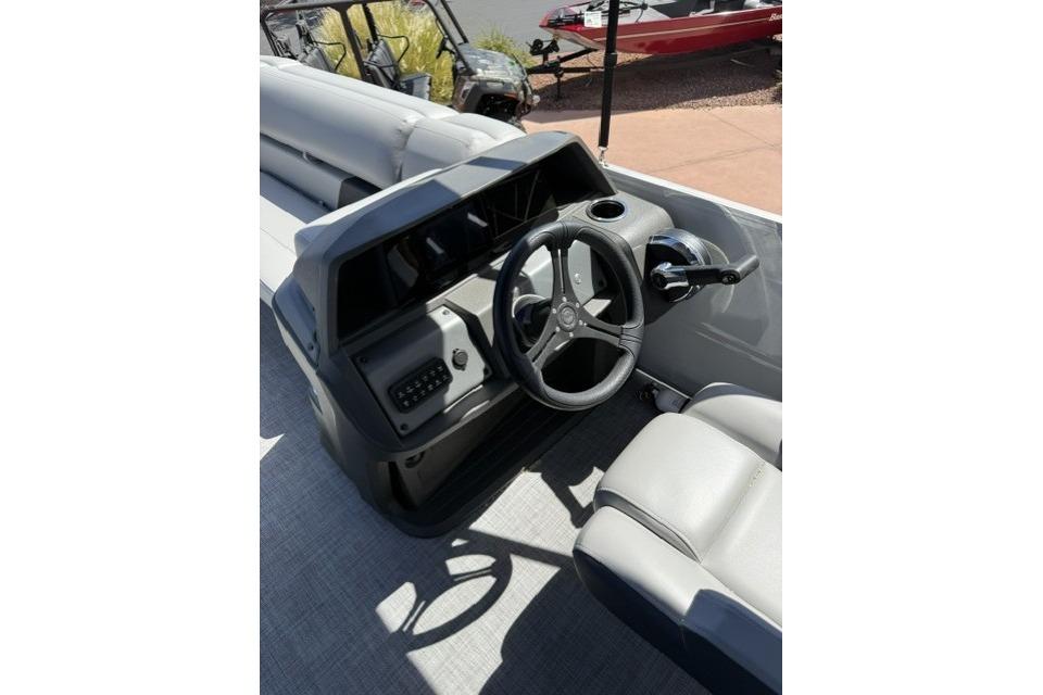 2026 Sun Tracker Party Barge 20 DLX steering console with modern controls and seating.
