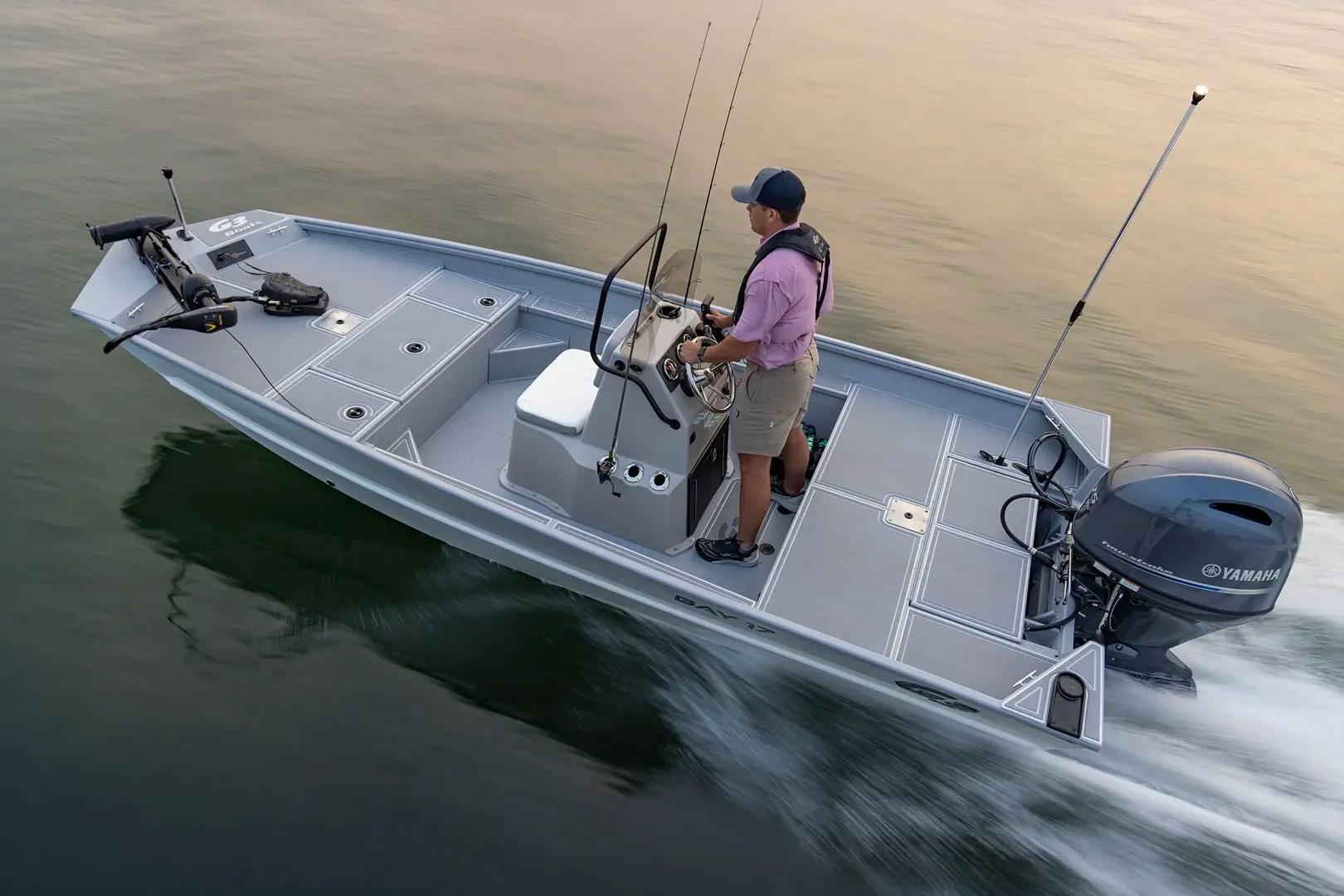 Manufacturer Provided Image: Man steering 2026 G3 Bay 17 boat on calm water.