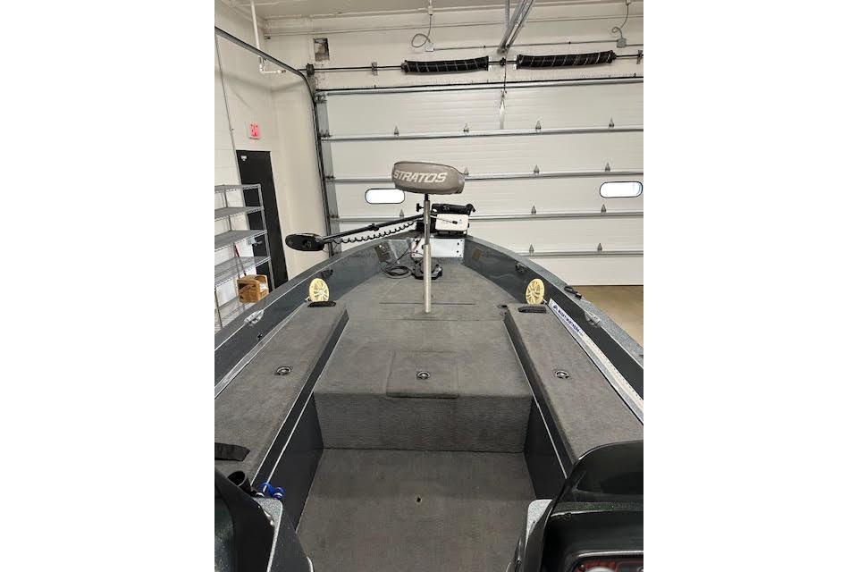 1999 Stratos 219 CF boat interior with trolling motor in garage.