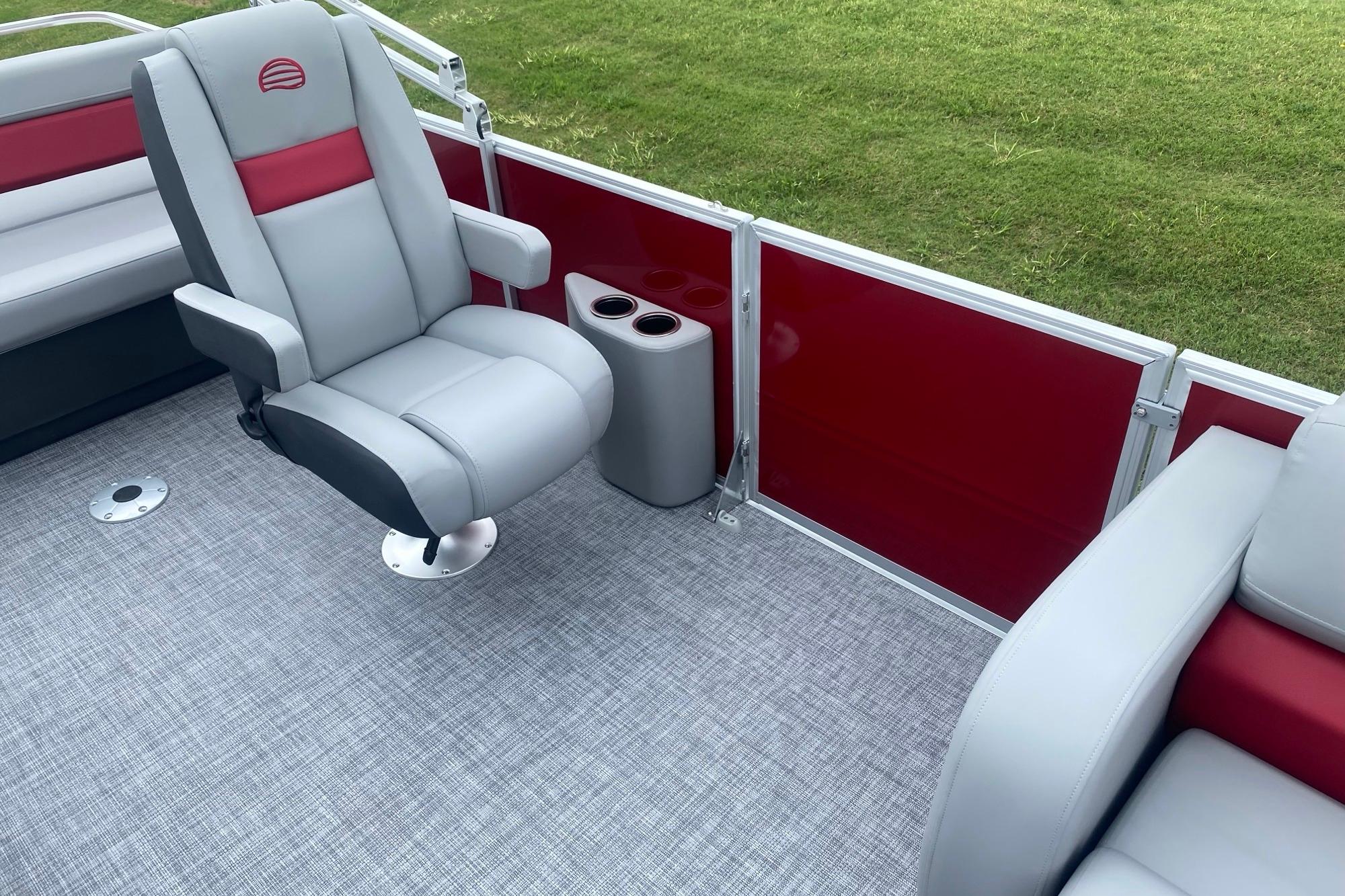 2026 Sun Tracker Party Barge 22 RF DLX interior with gray seating and red accents.