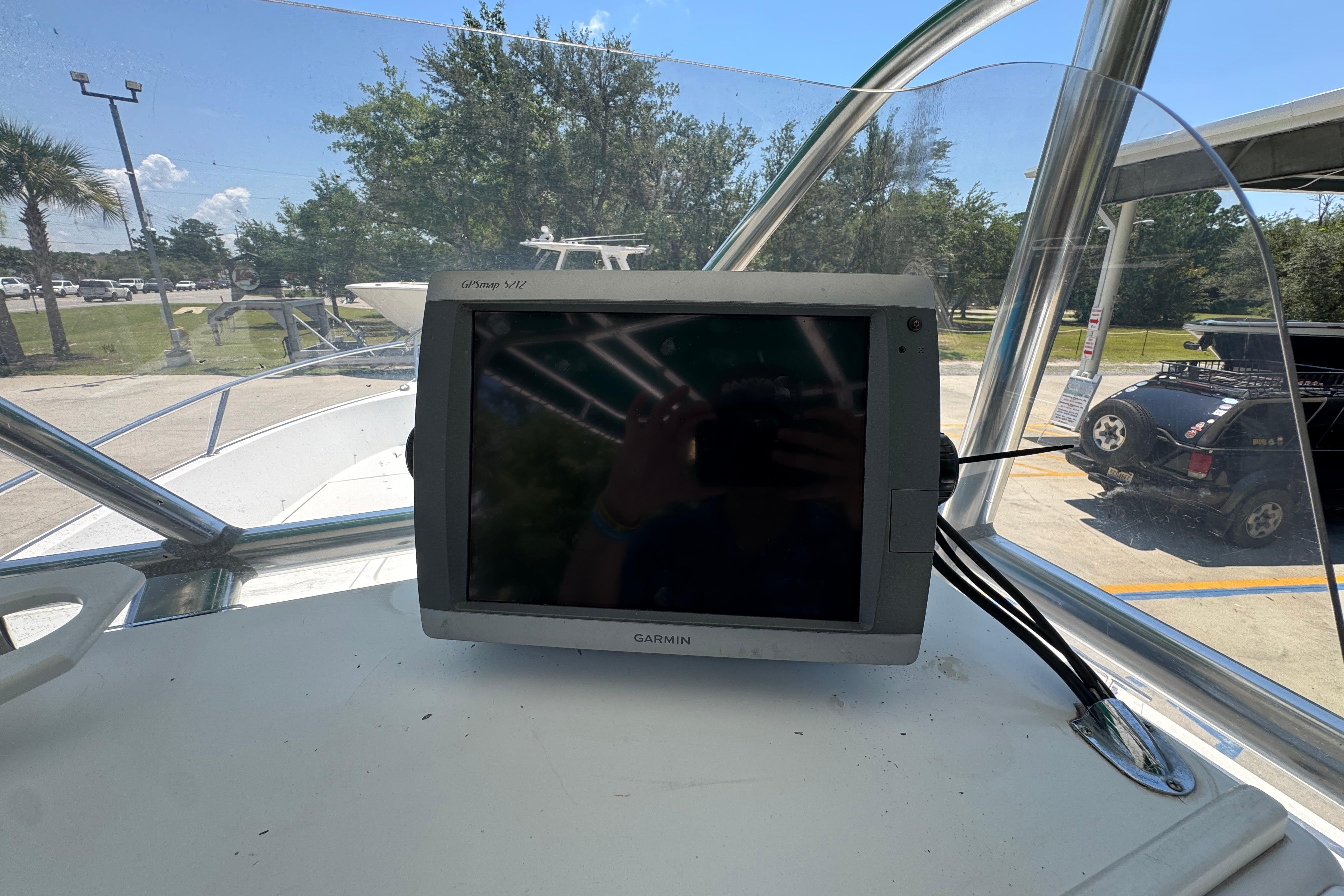 Garmin GPSmap 5212 on 2000 Stamas 250 Tarpon boat dashboard, outdoor setting.